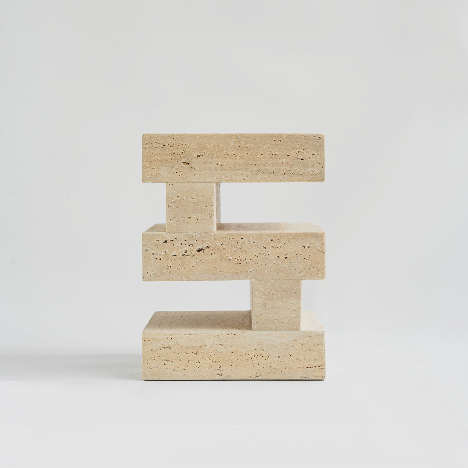 Travertine side table with sculptural zigzag design