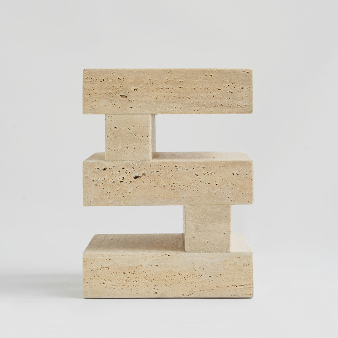 Travertine side table with sculptural zigzag design