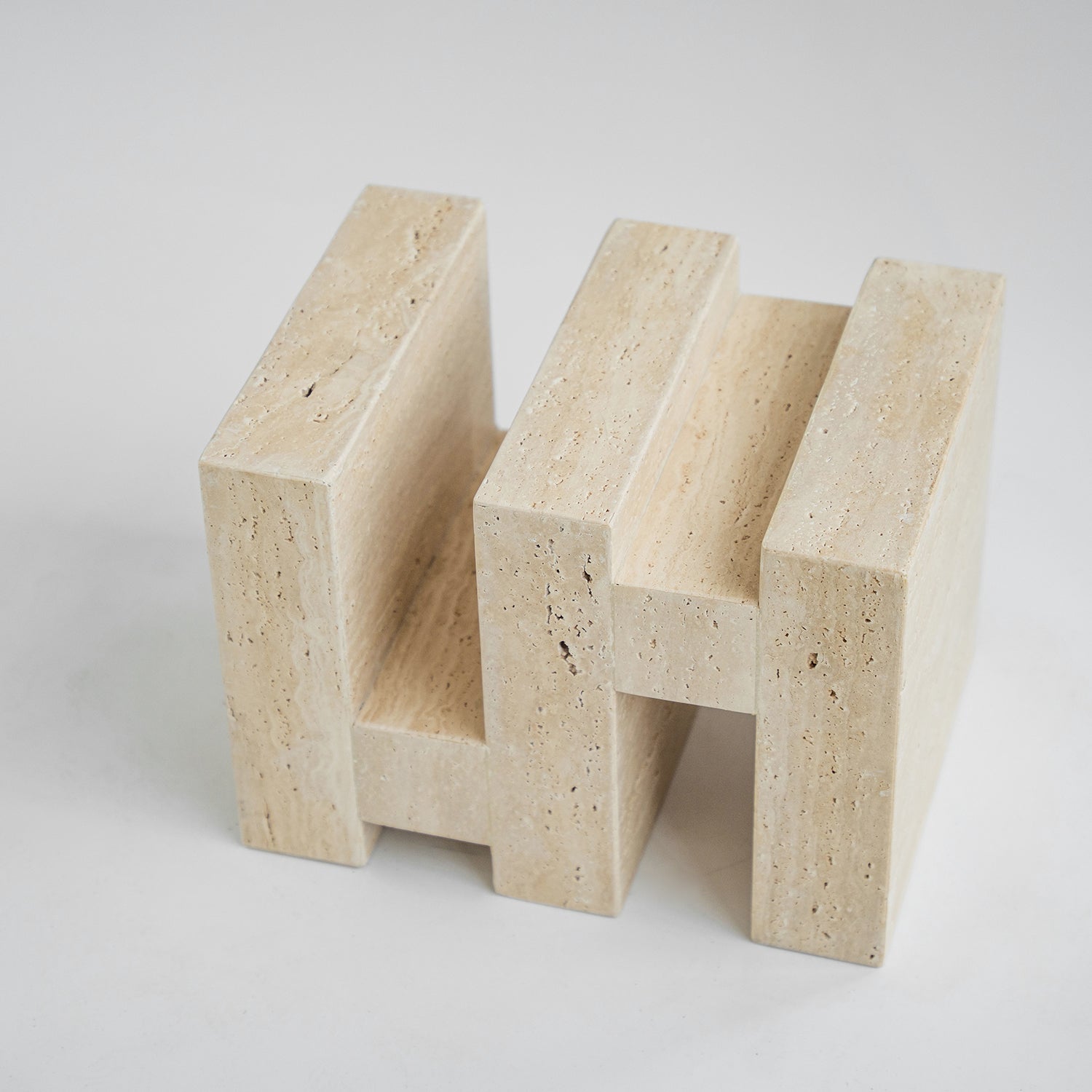 Travertine side table with sculptural zigzag design