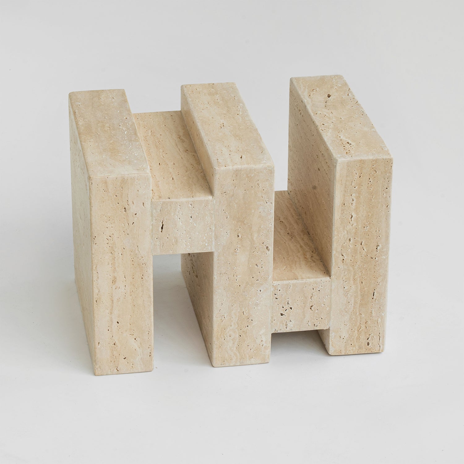 Travertine side table with sculptural zigzag design