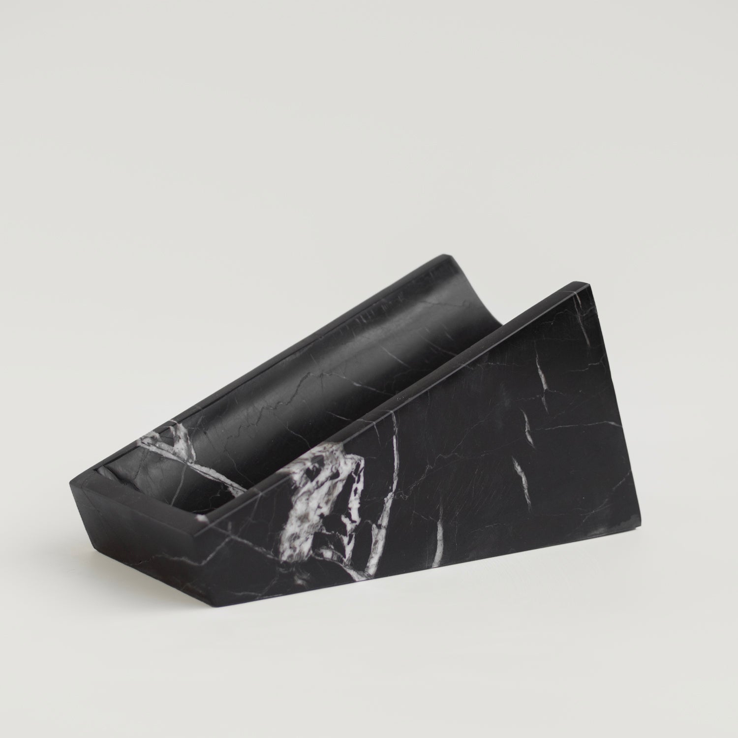 Black marble wine holder on white stone counter