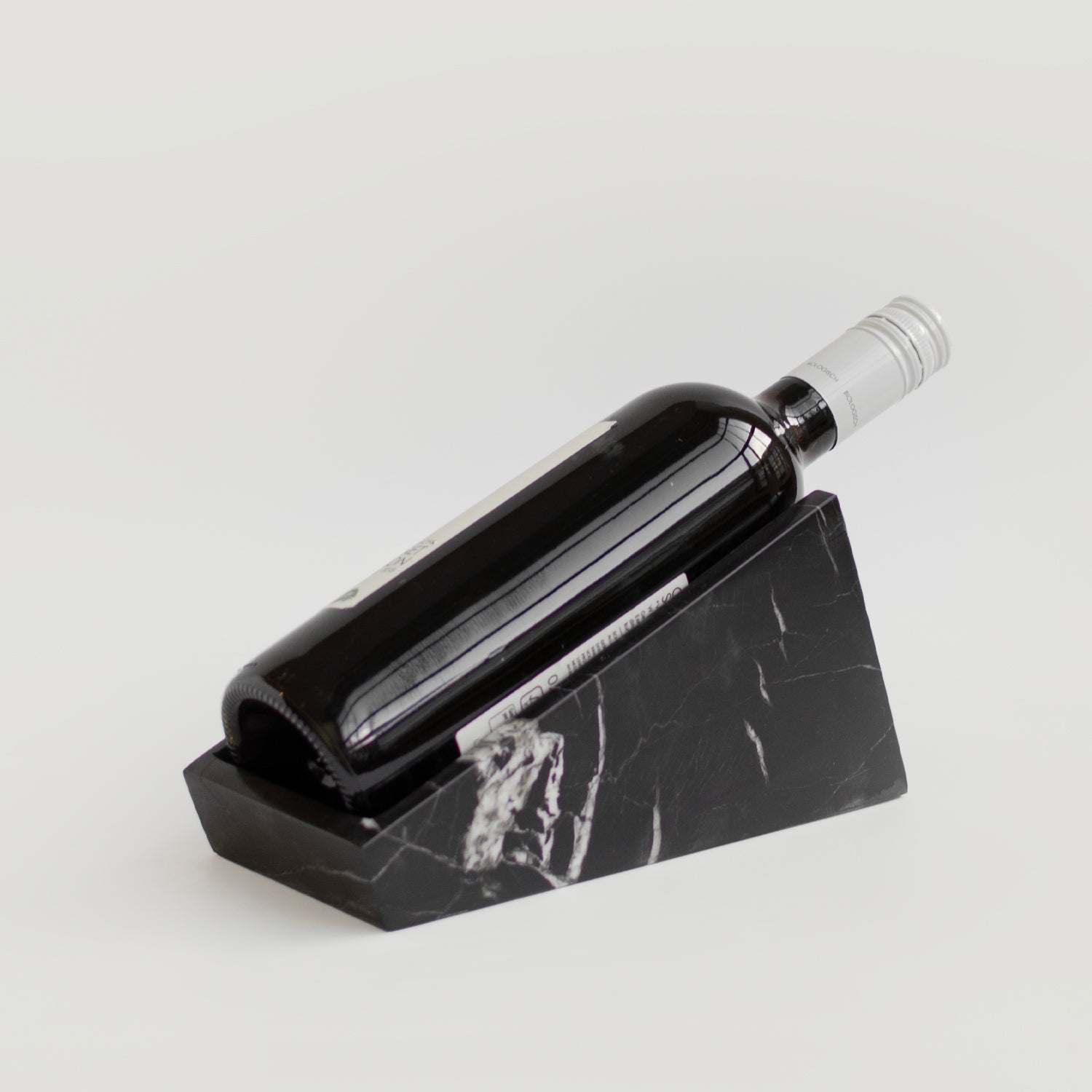 Black marble wine holder on white stone counter
