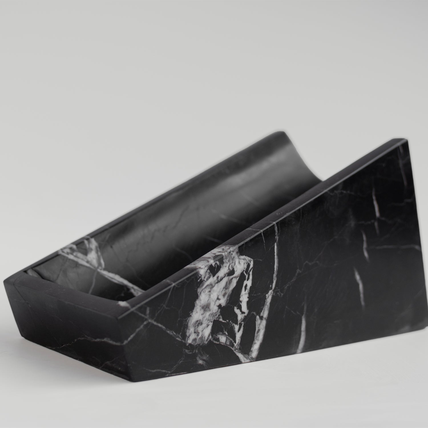 Black marble wine holder on white stone counter