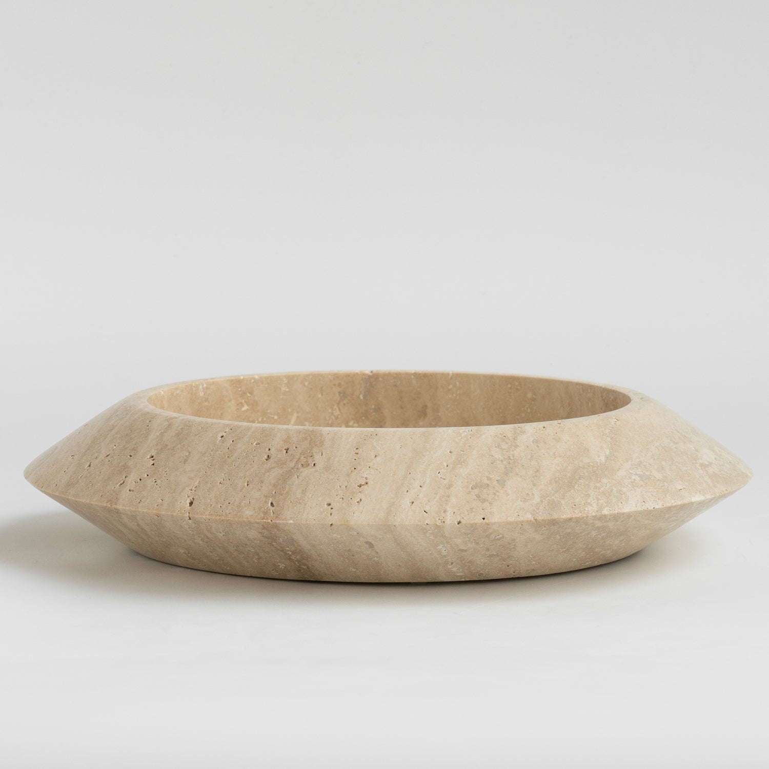 Decorative travertine bowl with natural stone texture