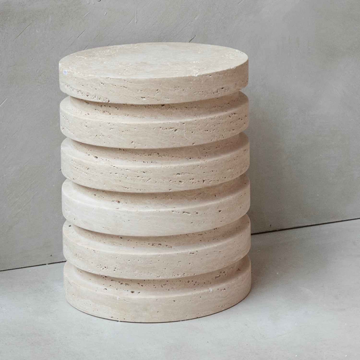 Layered travertine side table with sculptural stone base