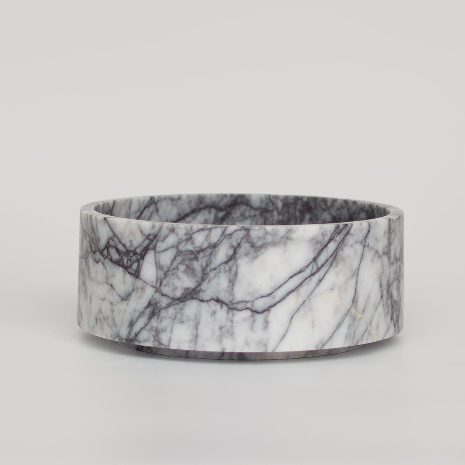 Lilac marble bowl used in travertine home decor setup