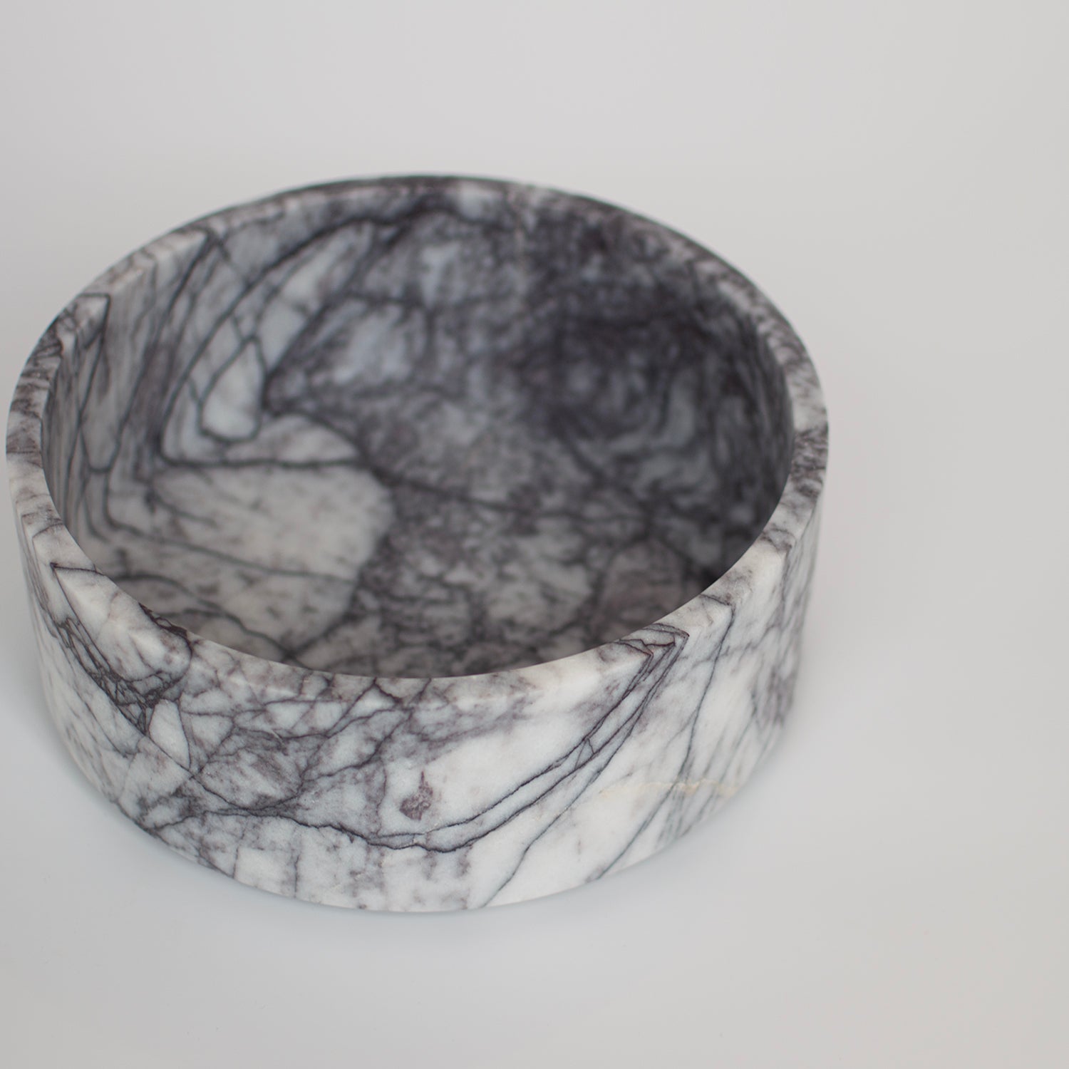 Lilac marble bowl used in travertine home decor setup