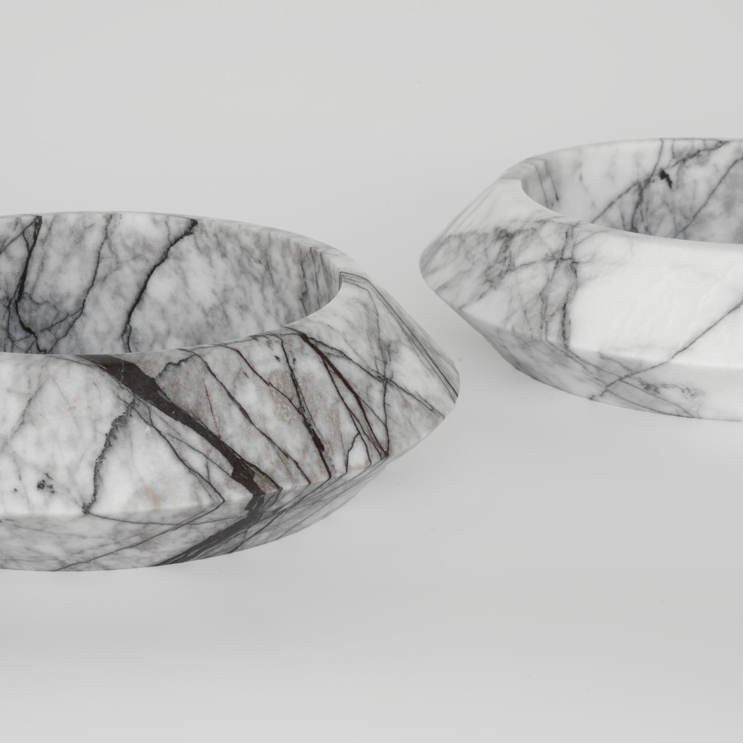 White marble bowl with lilac veining on flat surface