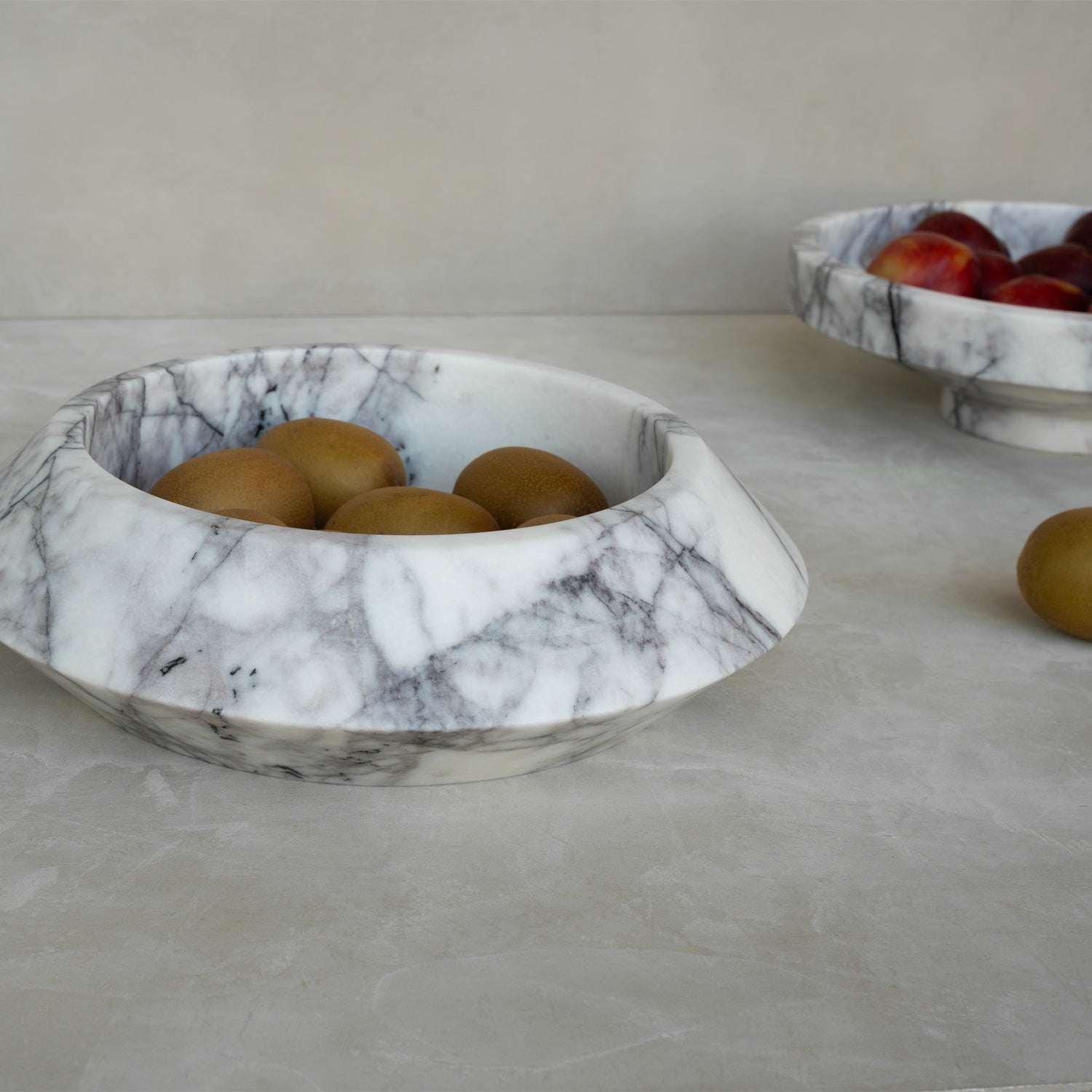 White marble bowl with lilac veining on flat surface