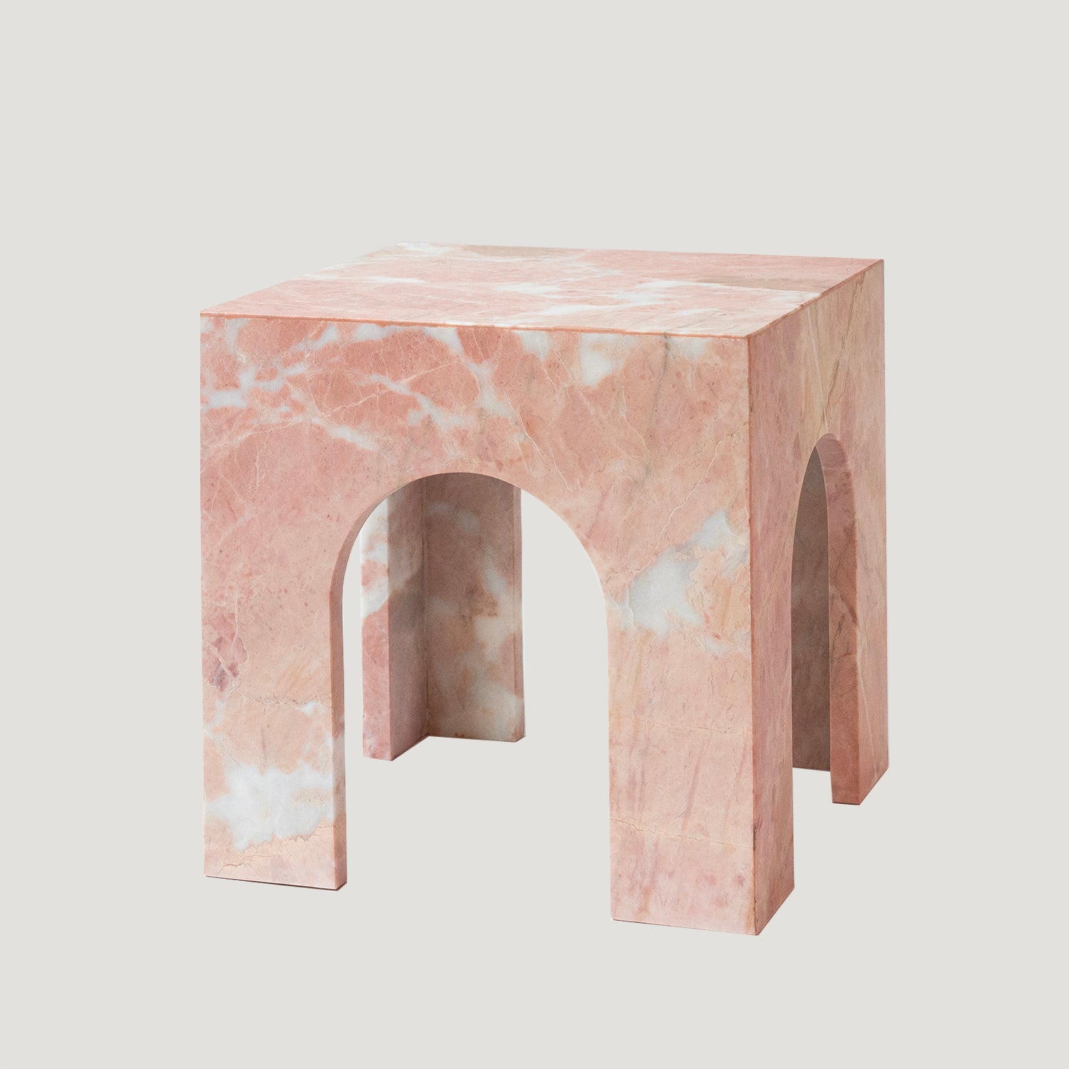 Pink marble side table with arched base and square top