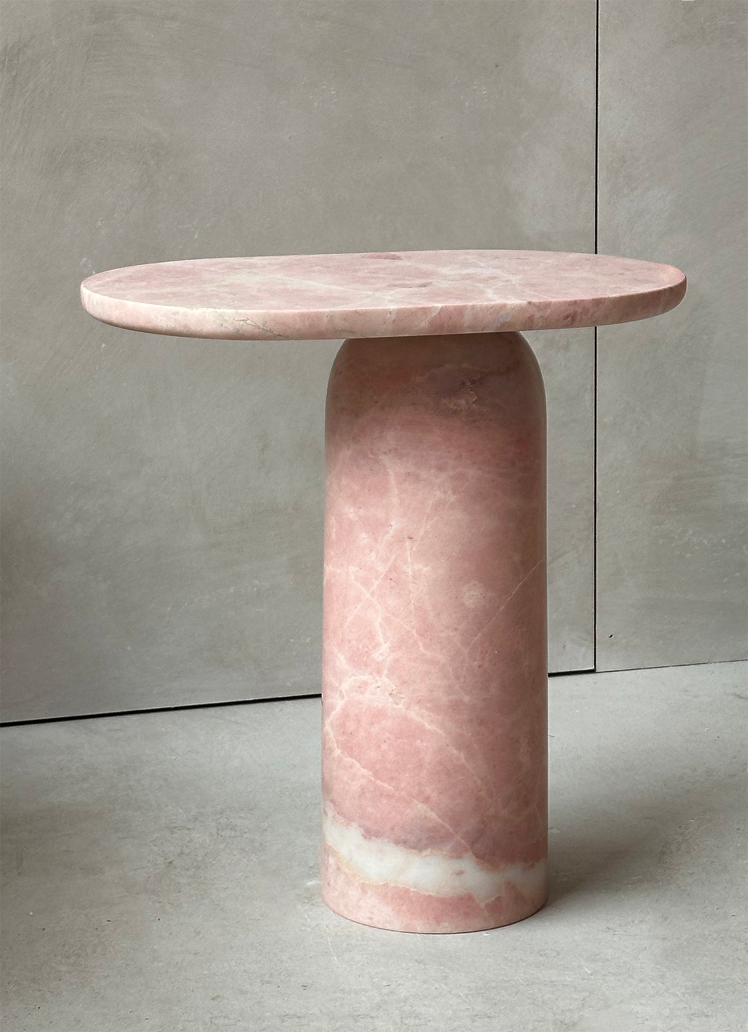 Pink marble side table with solid stone block design