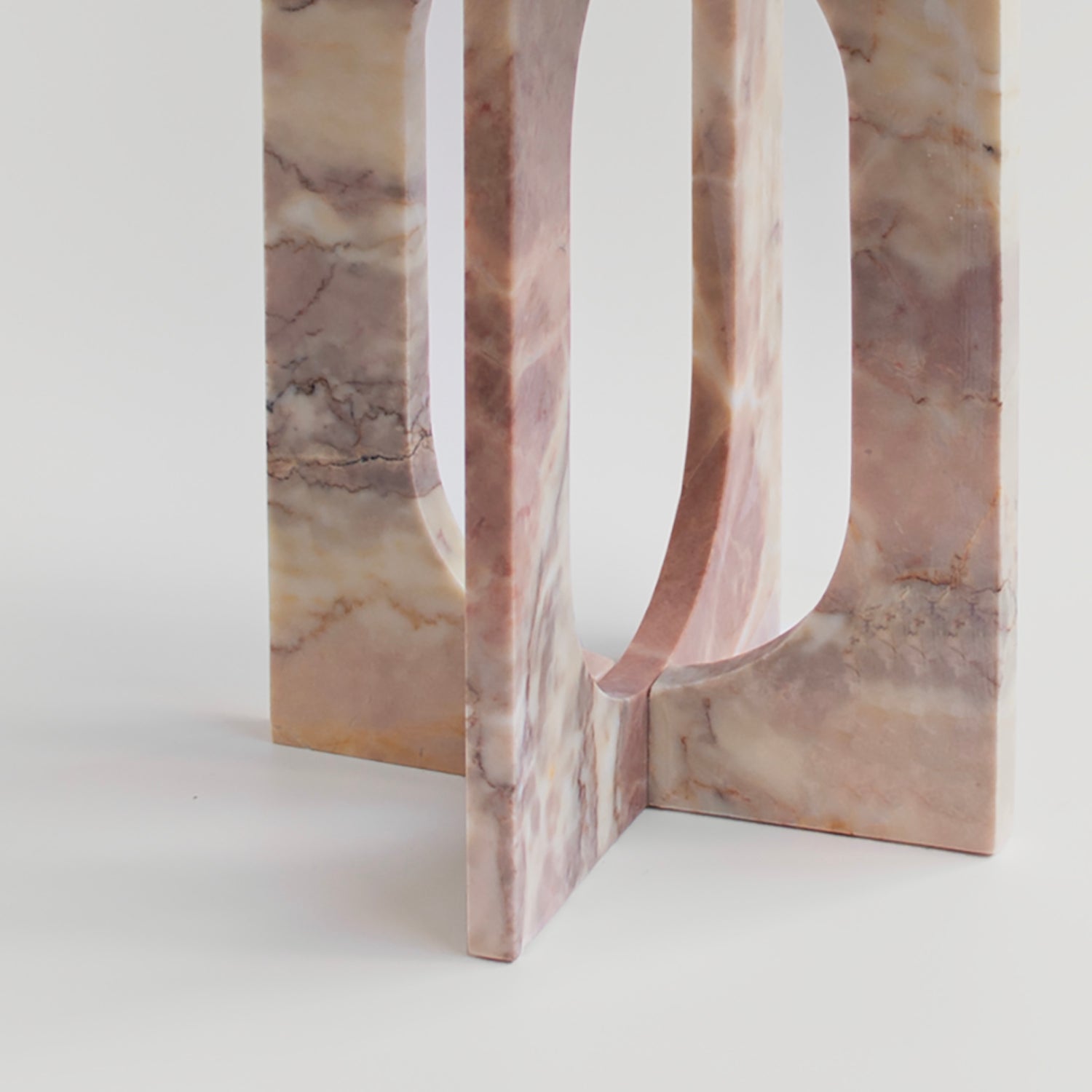 Pink marble side table with square top and stone base