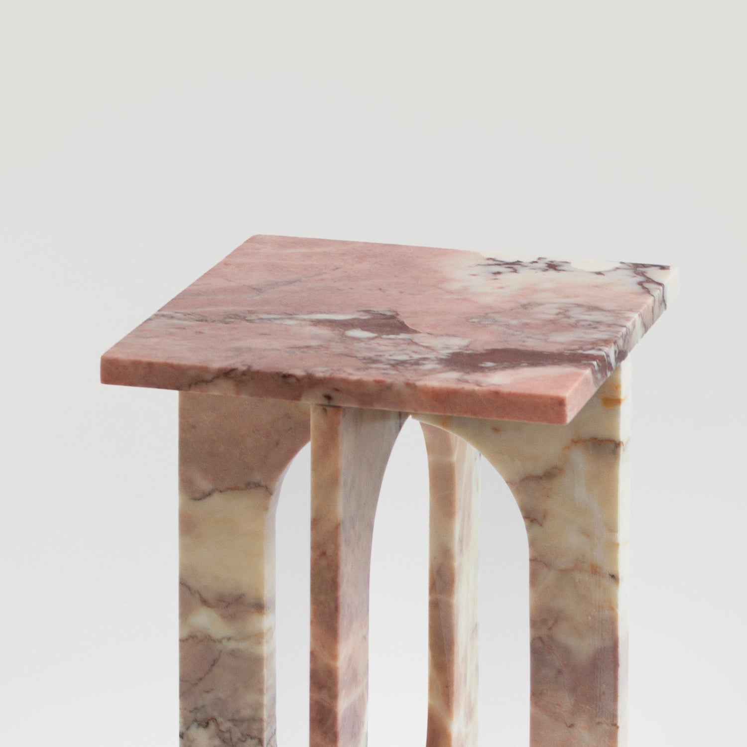 Pink marble side table with square top and stone base