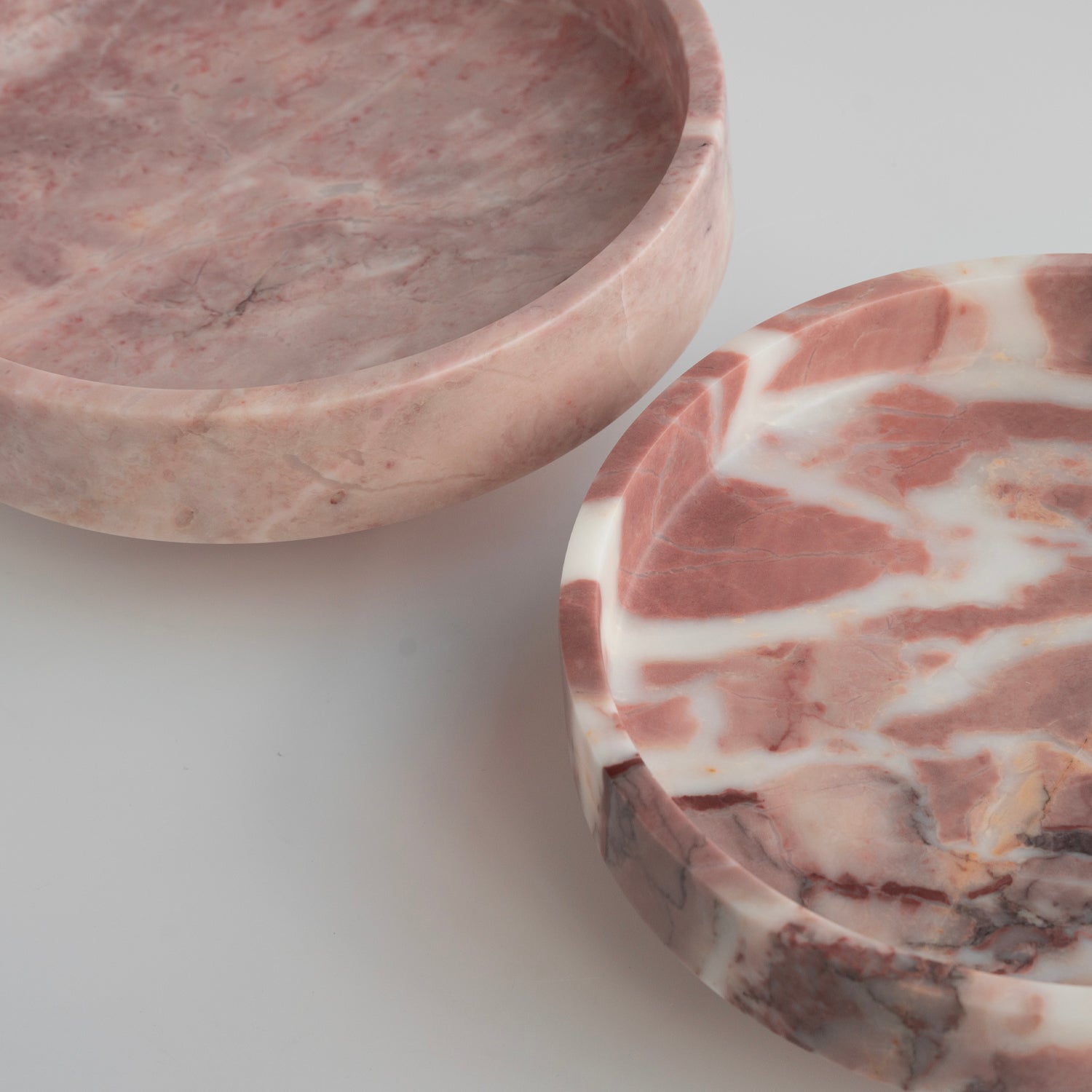 Pink marble bowl with rounded shape on neutral surface