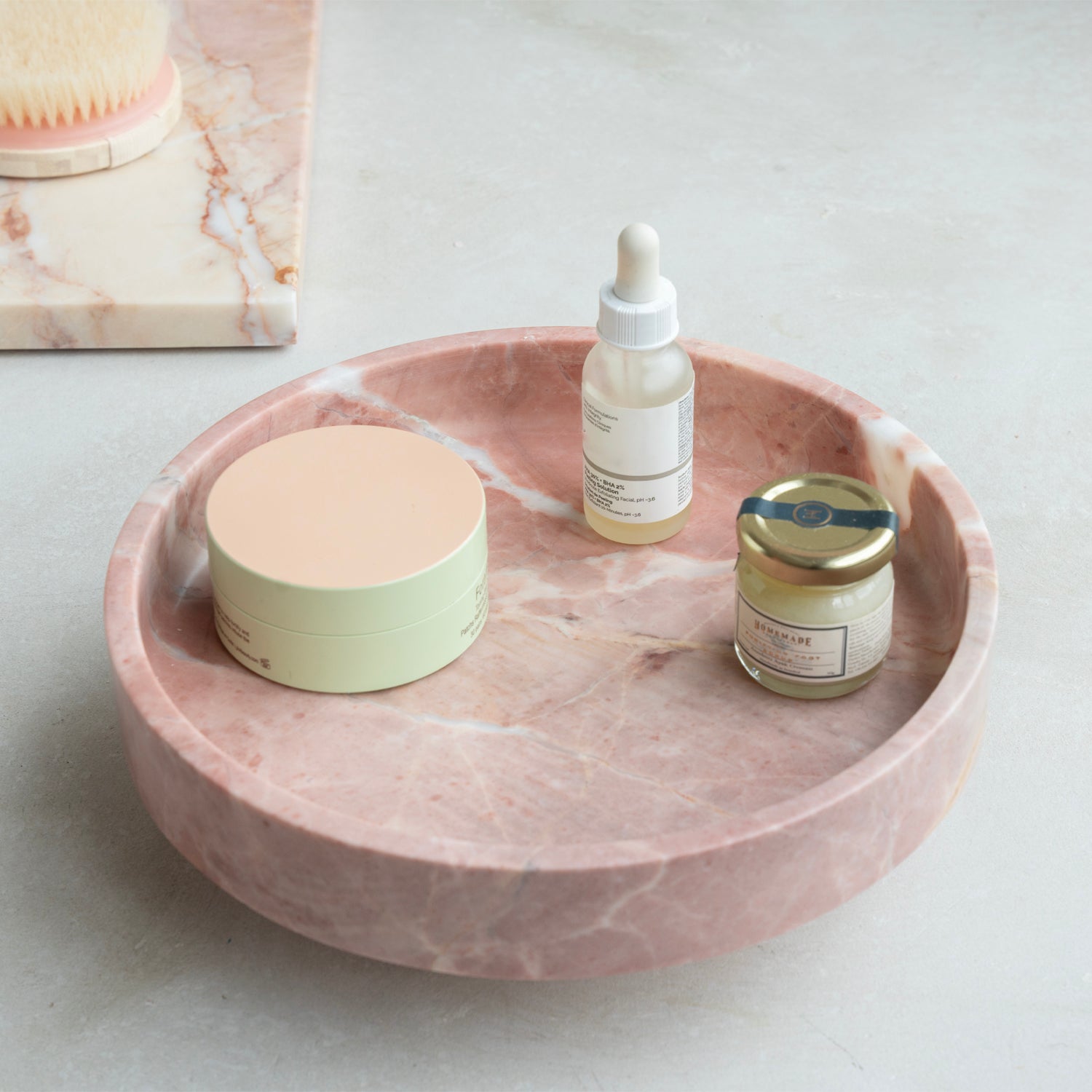 Pink marble bowl with rounded shape on neutral surface