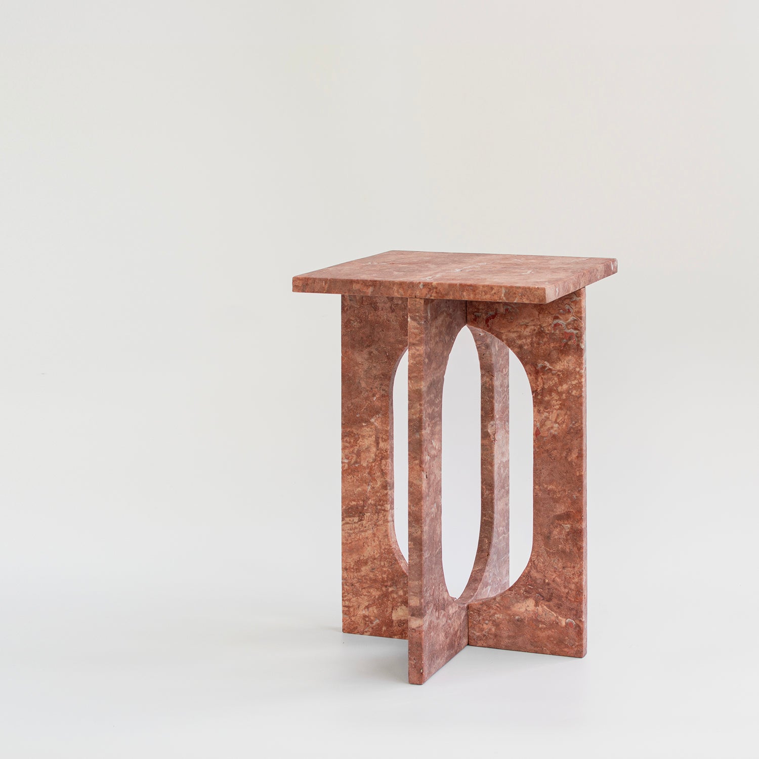 Red travertine marble side table with clean stone lines
