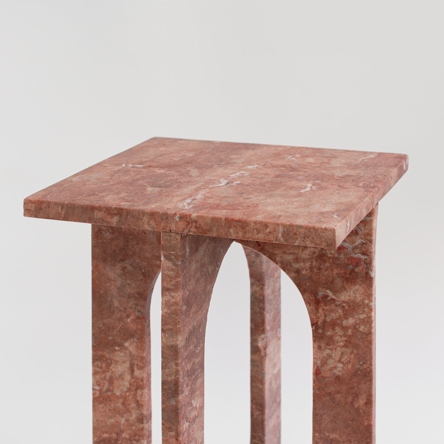 Red travertine marble side table with clean stone lines