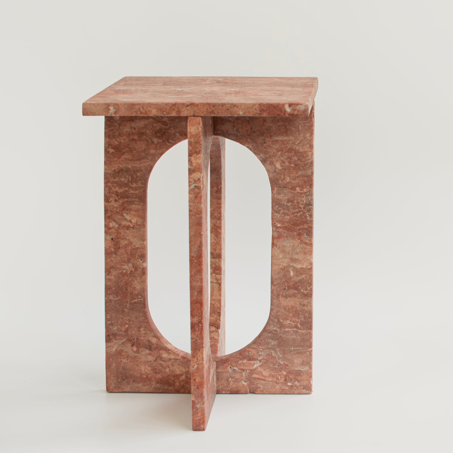 Red travertine marble side table with clean stone lines