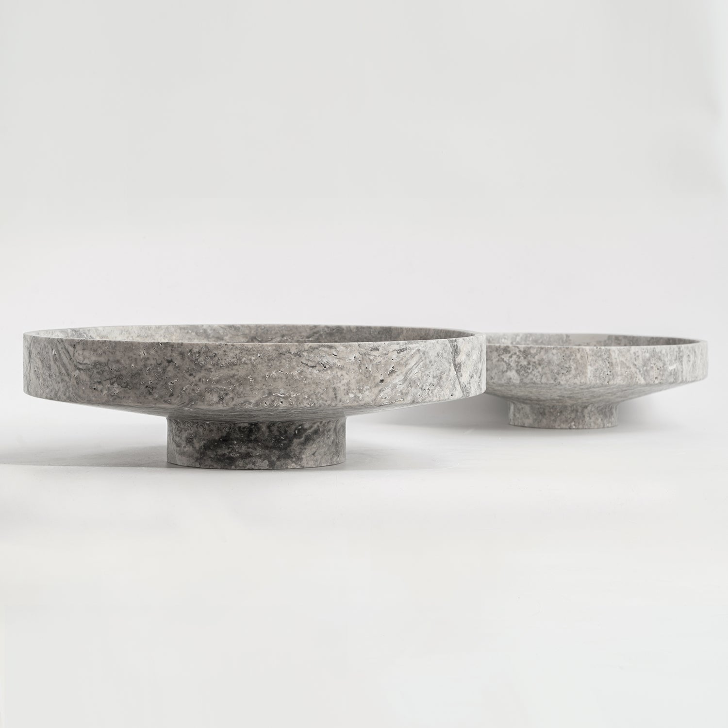 Silver travertine bowl with wide opening on display