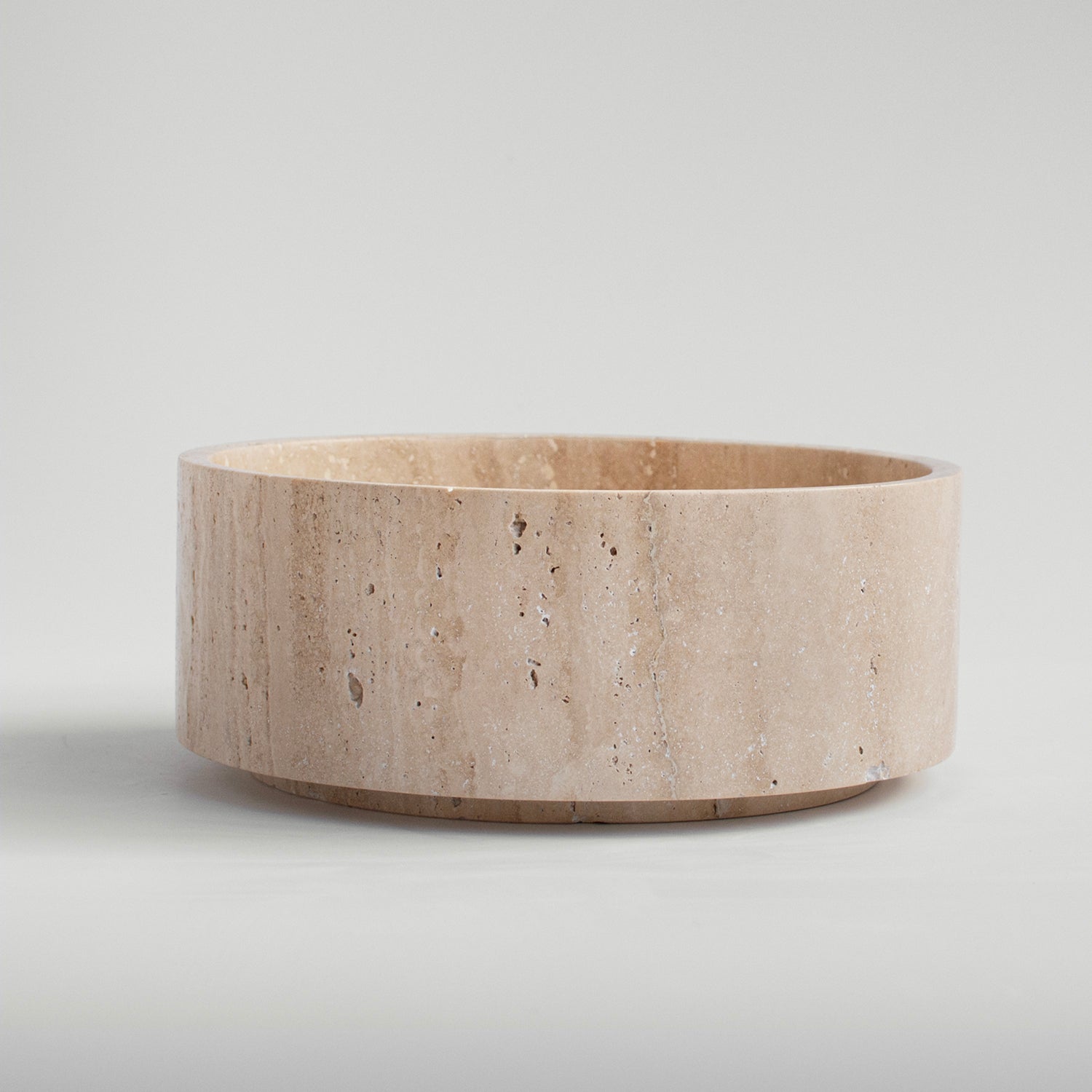 Sculptural travertine bowl with matte stone finish
