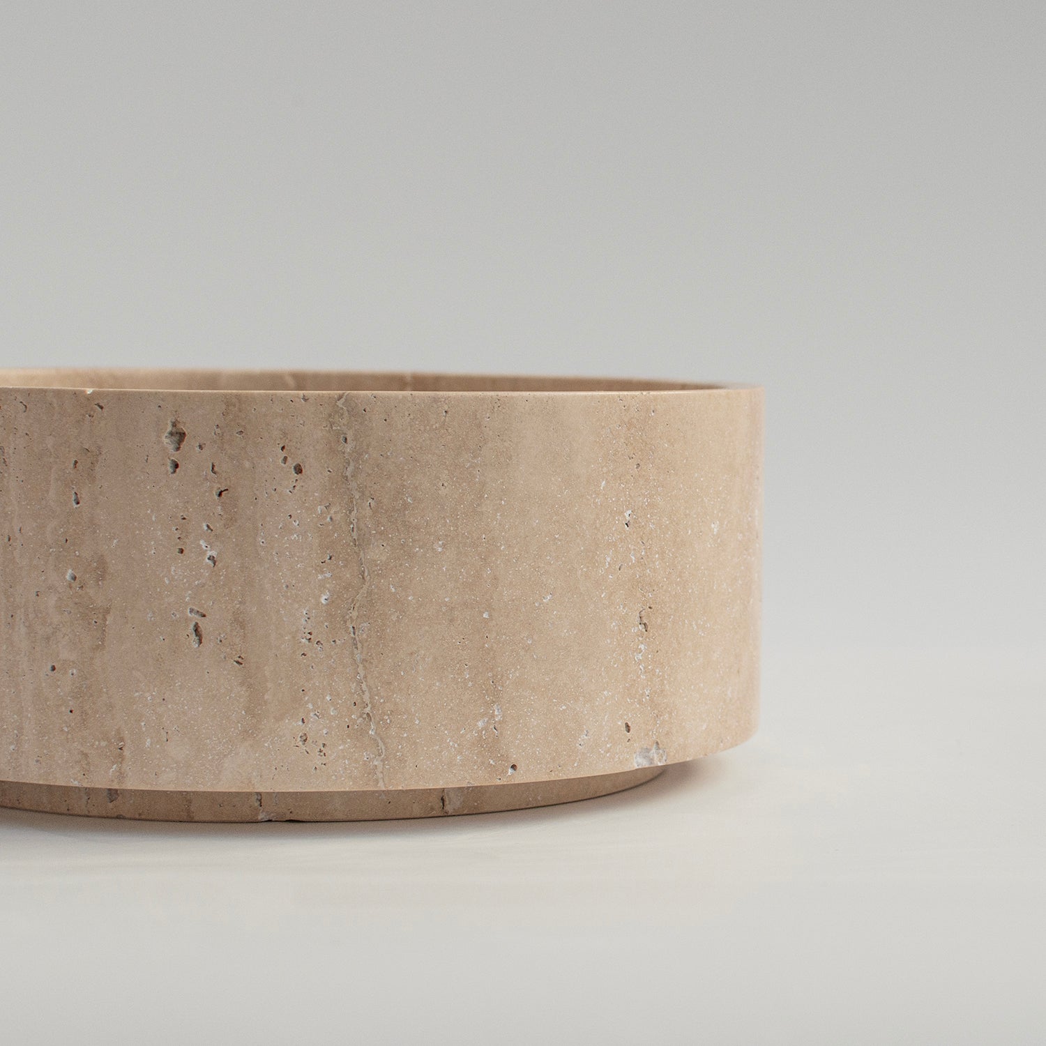 Sculptural travertine bowl with matte stone finish