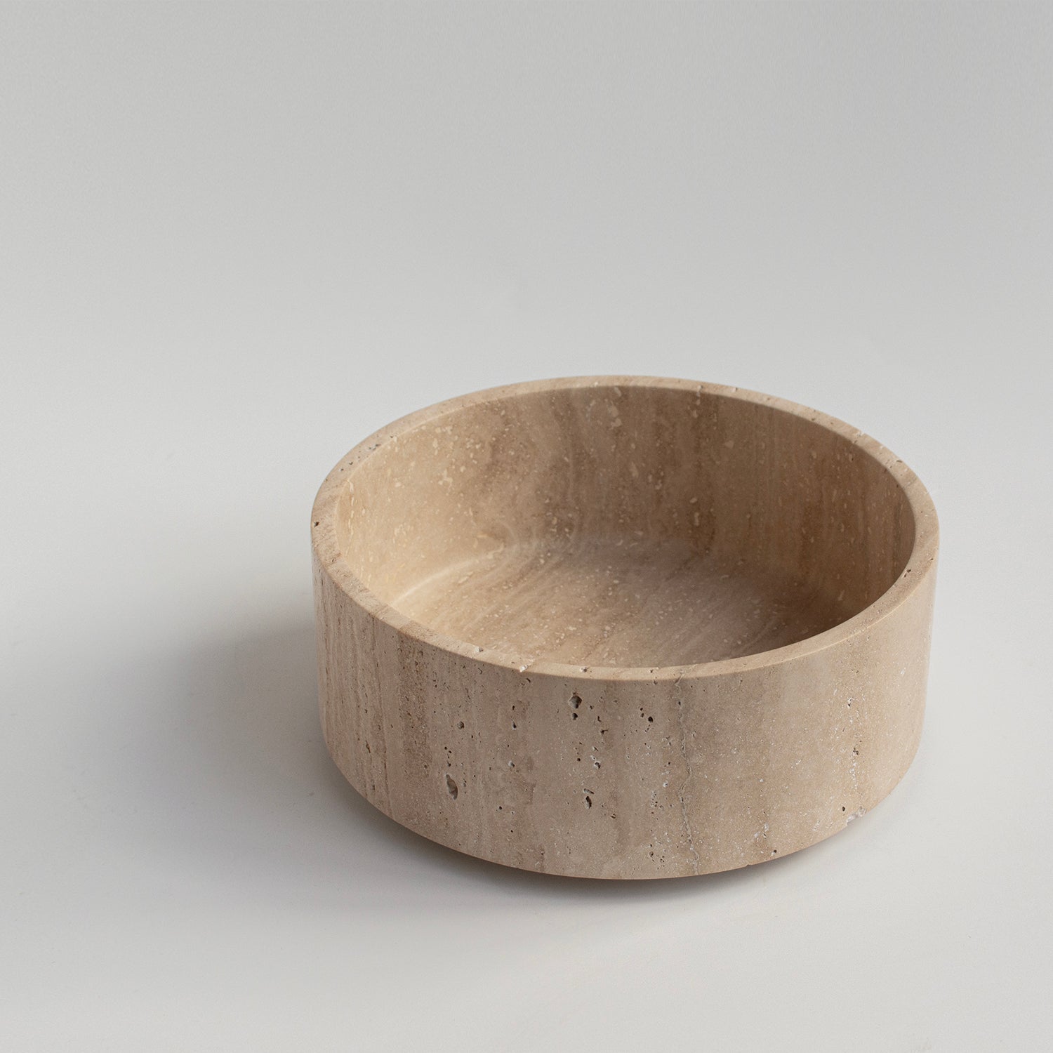 Sculptural travertine bowl with matte stone finish