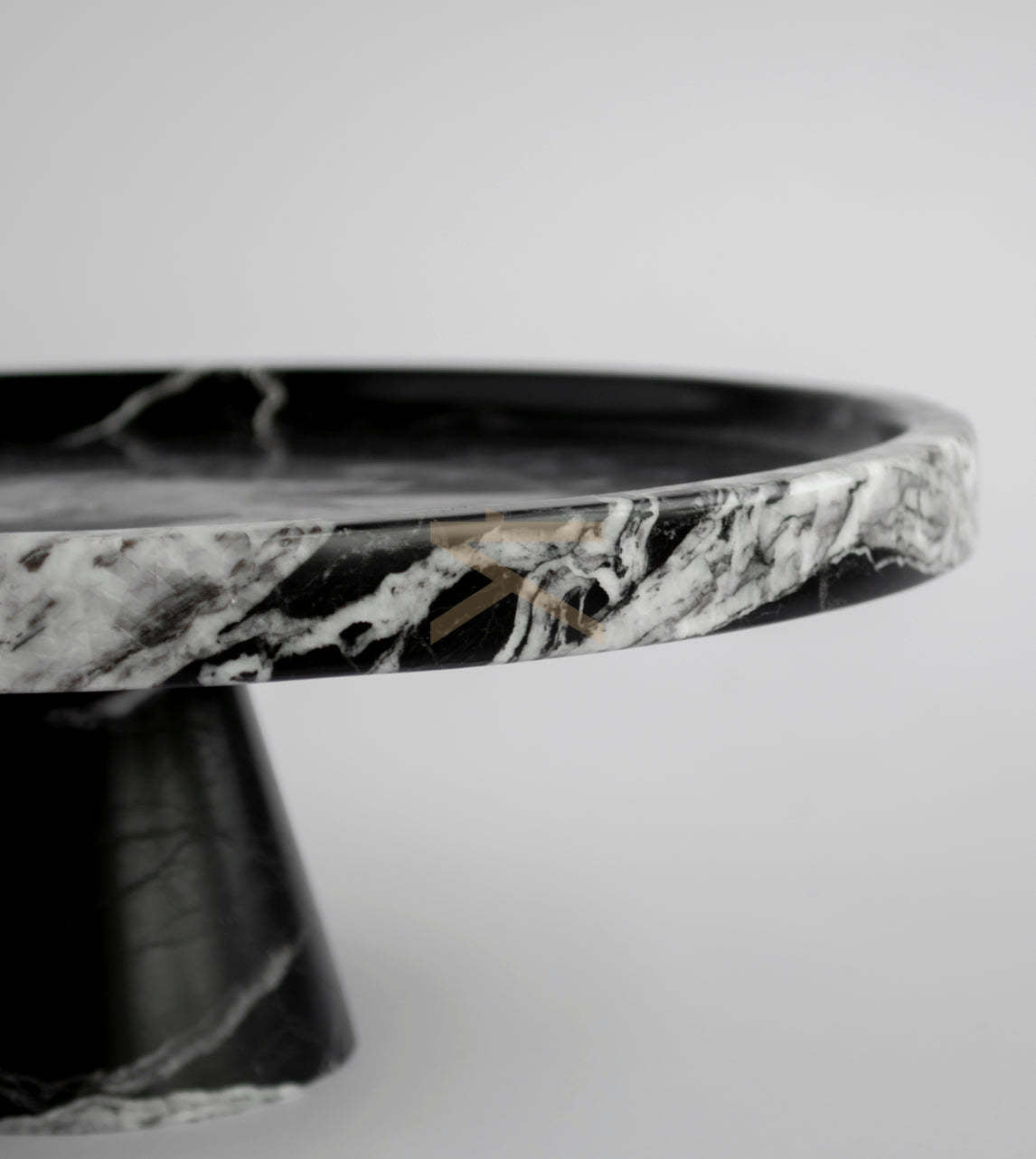 Black marble cake stand on display