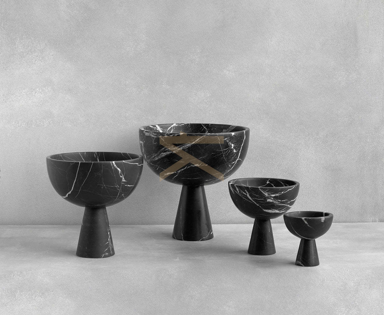 Black marble pedestal bowl with white veining on table