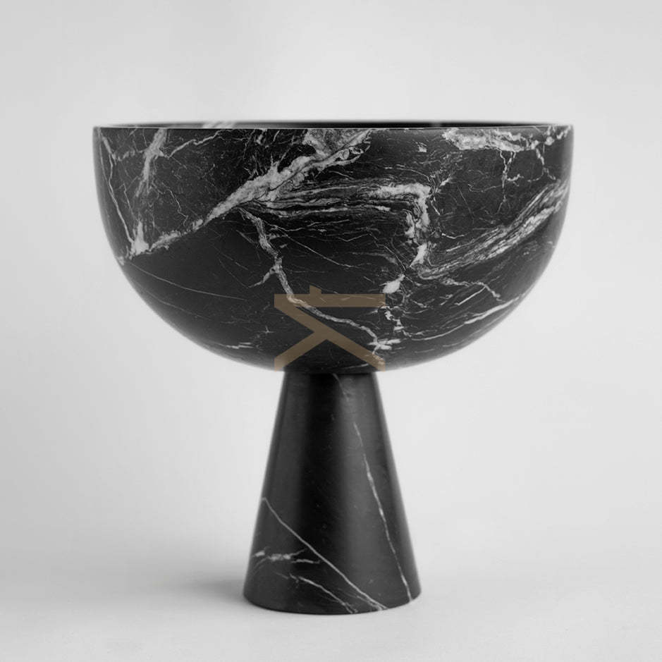 Black marble pedestal bowl with white veining on table