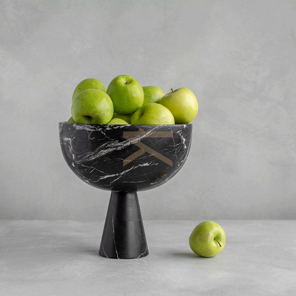 Black marble pedestal bowl with white veining on table