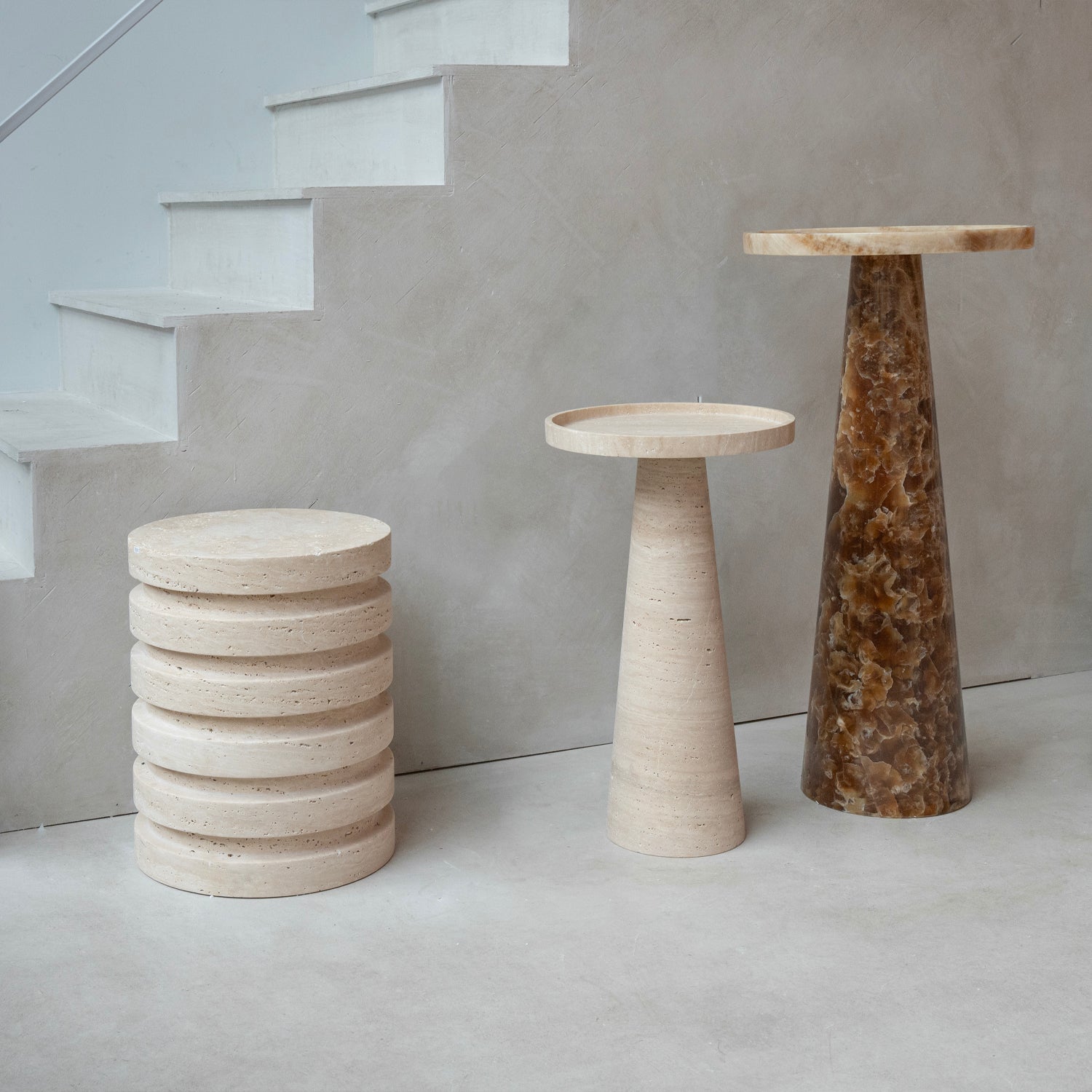 Layered travertine side table with sculptural stone base