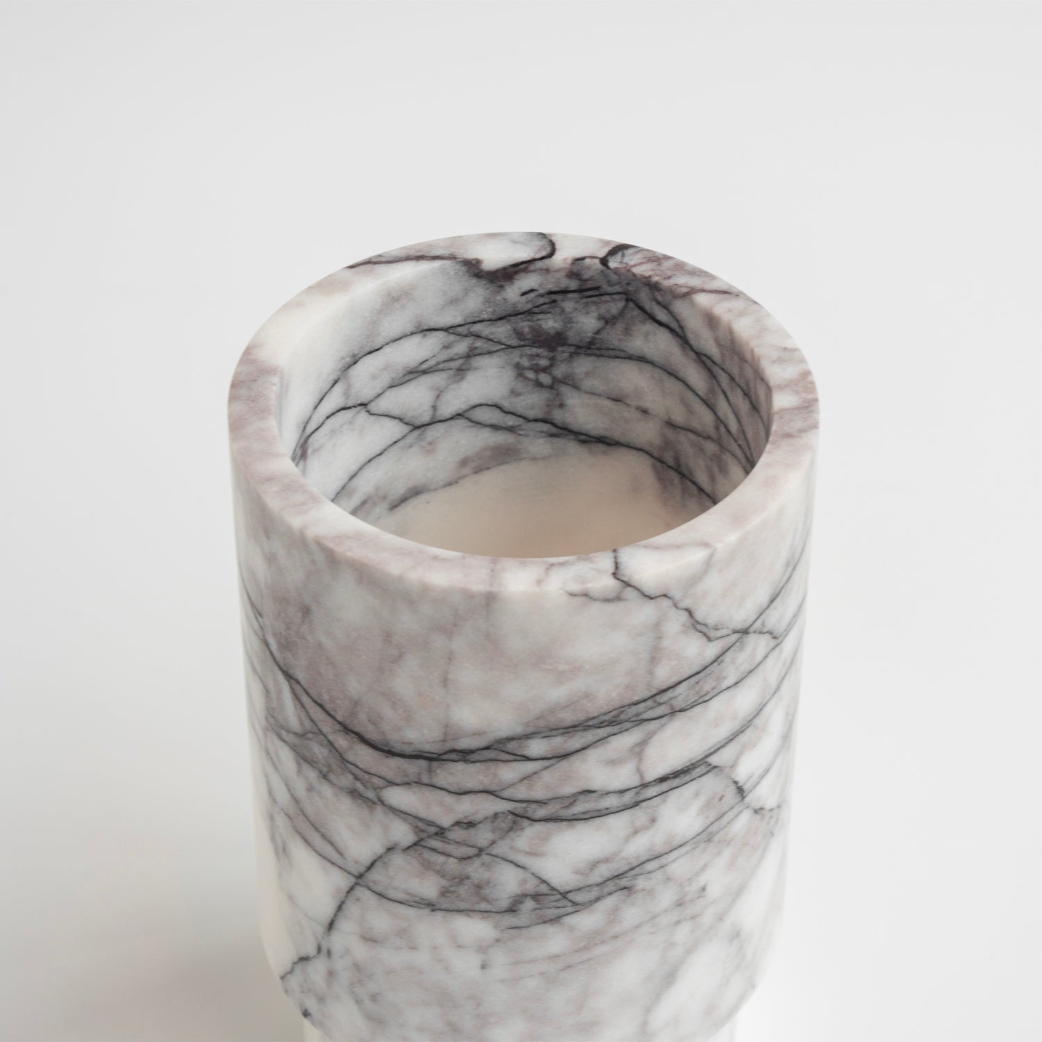 White marble vase used as wine bottle holder