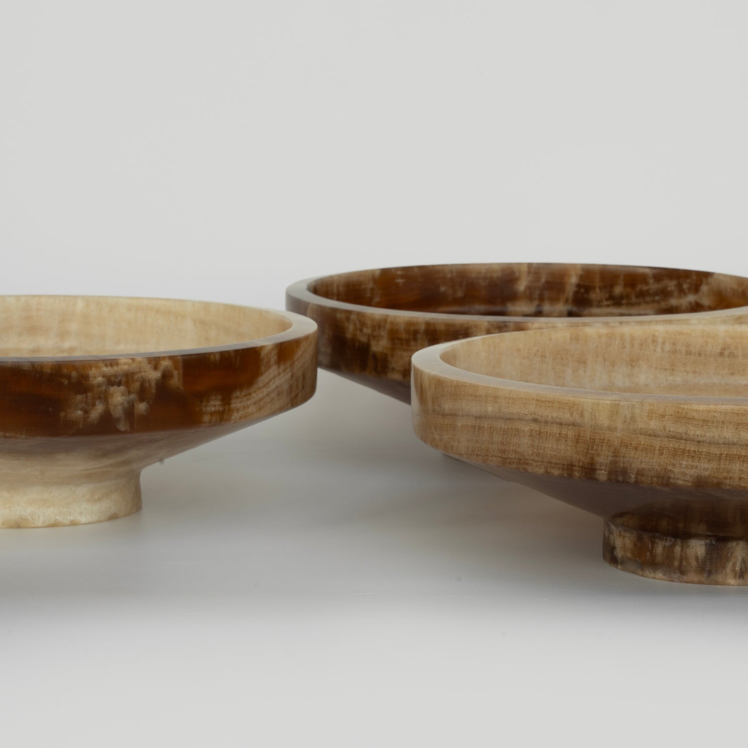 Onyx bowl with natural veining on white stone surface