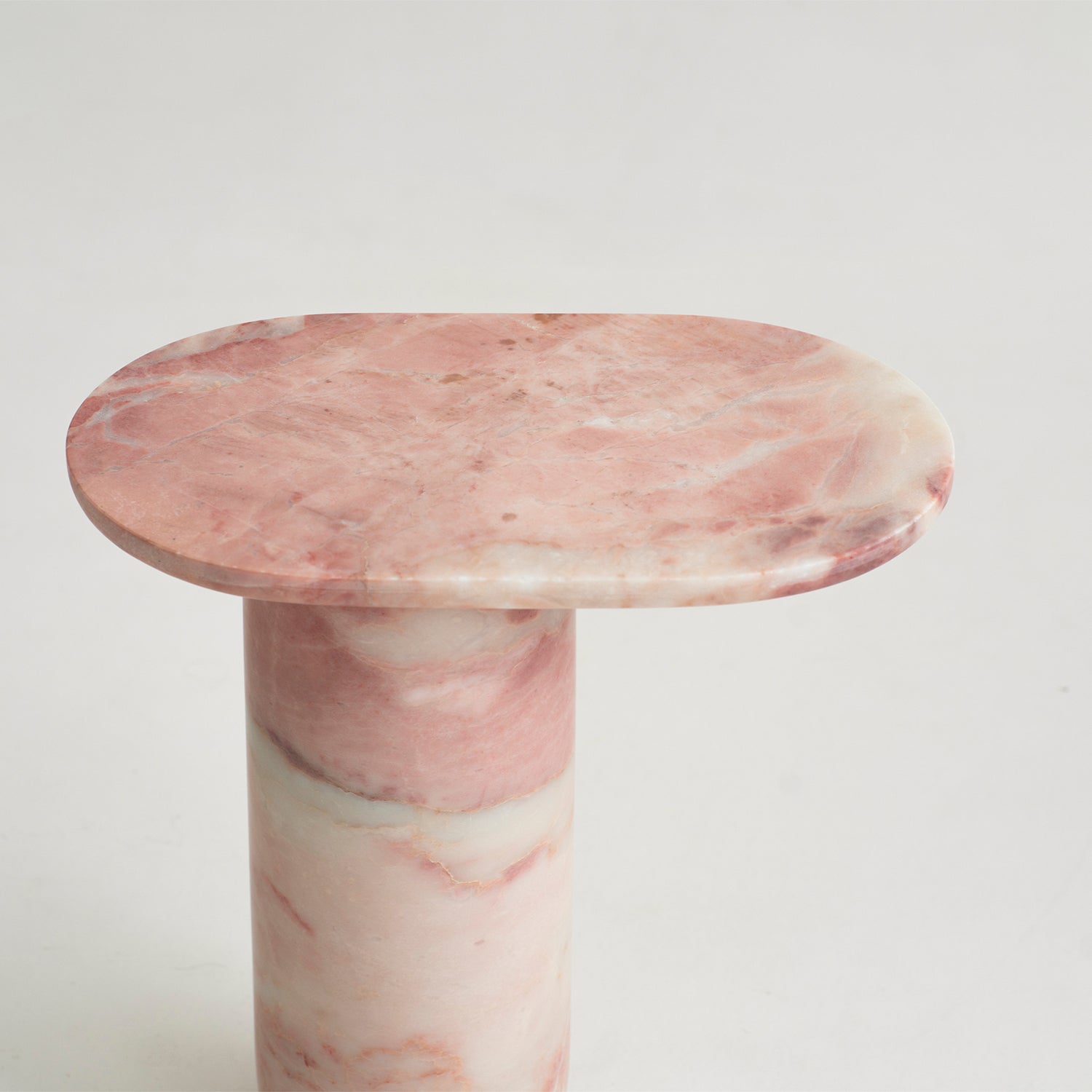 Pink marble side table with solid stone block design