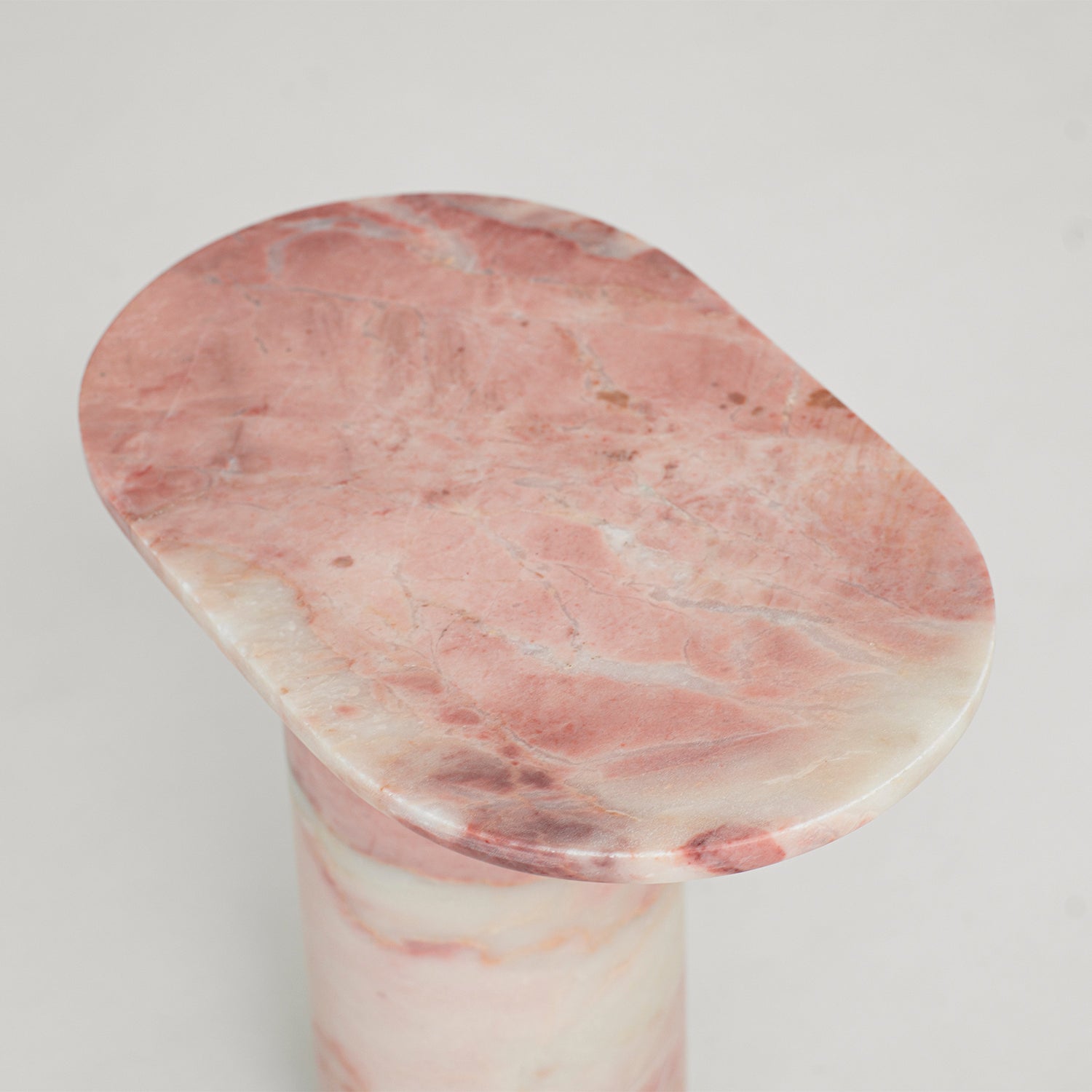 Pink marble side table with solid stone block design