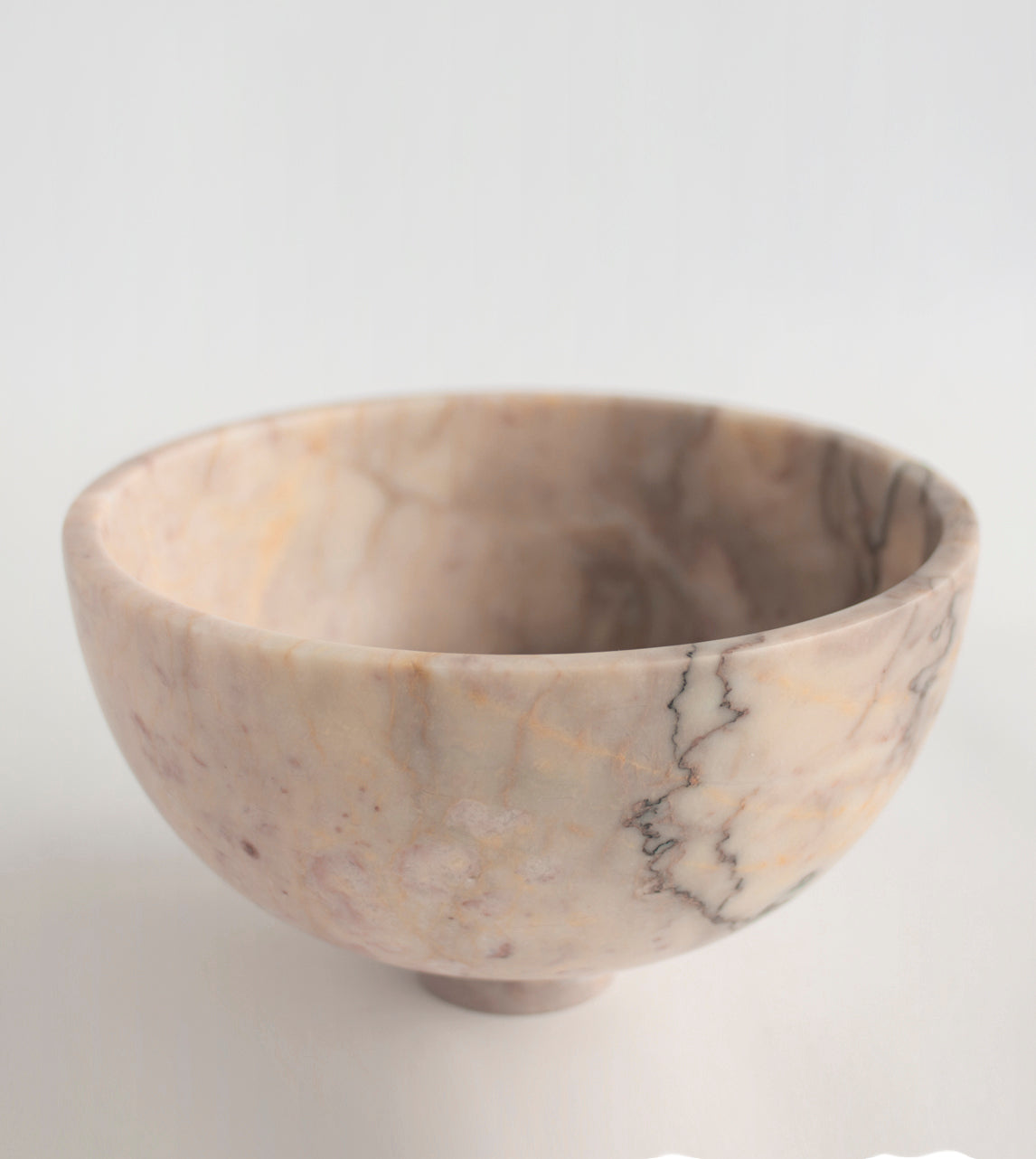 Pink marble fruit bowl with pedestal and white veining