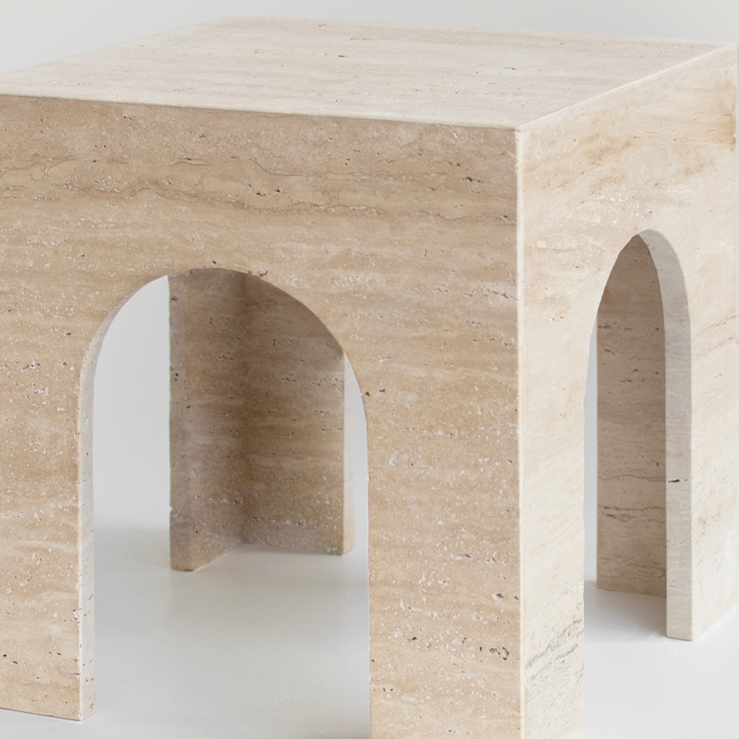 Travertine arch side table with marble top and curved base