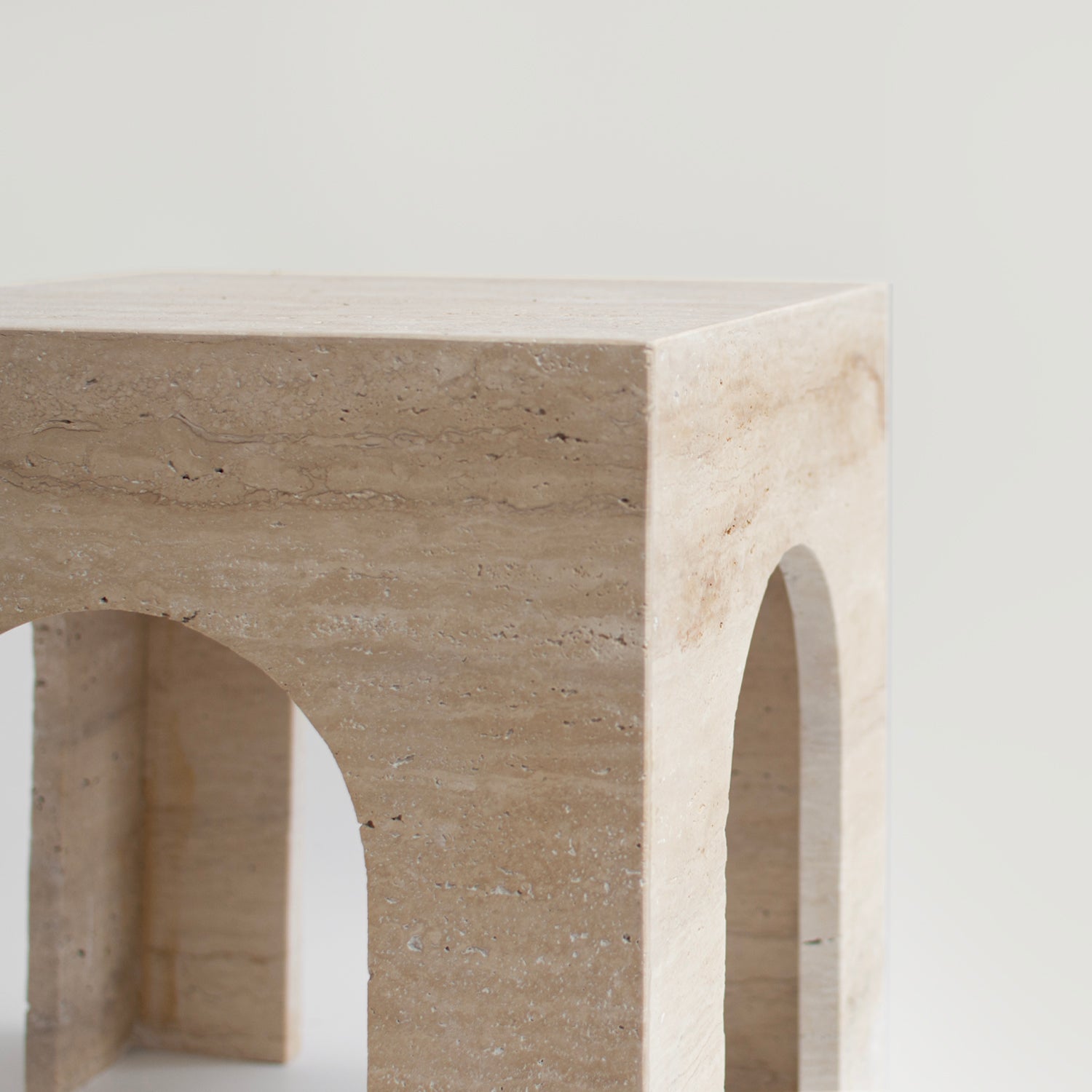 Travertine arch side table with marble top and curved base
