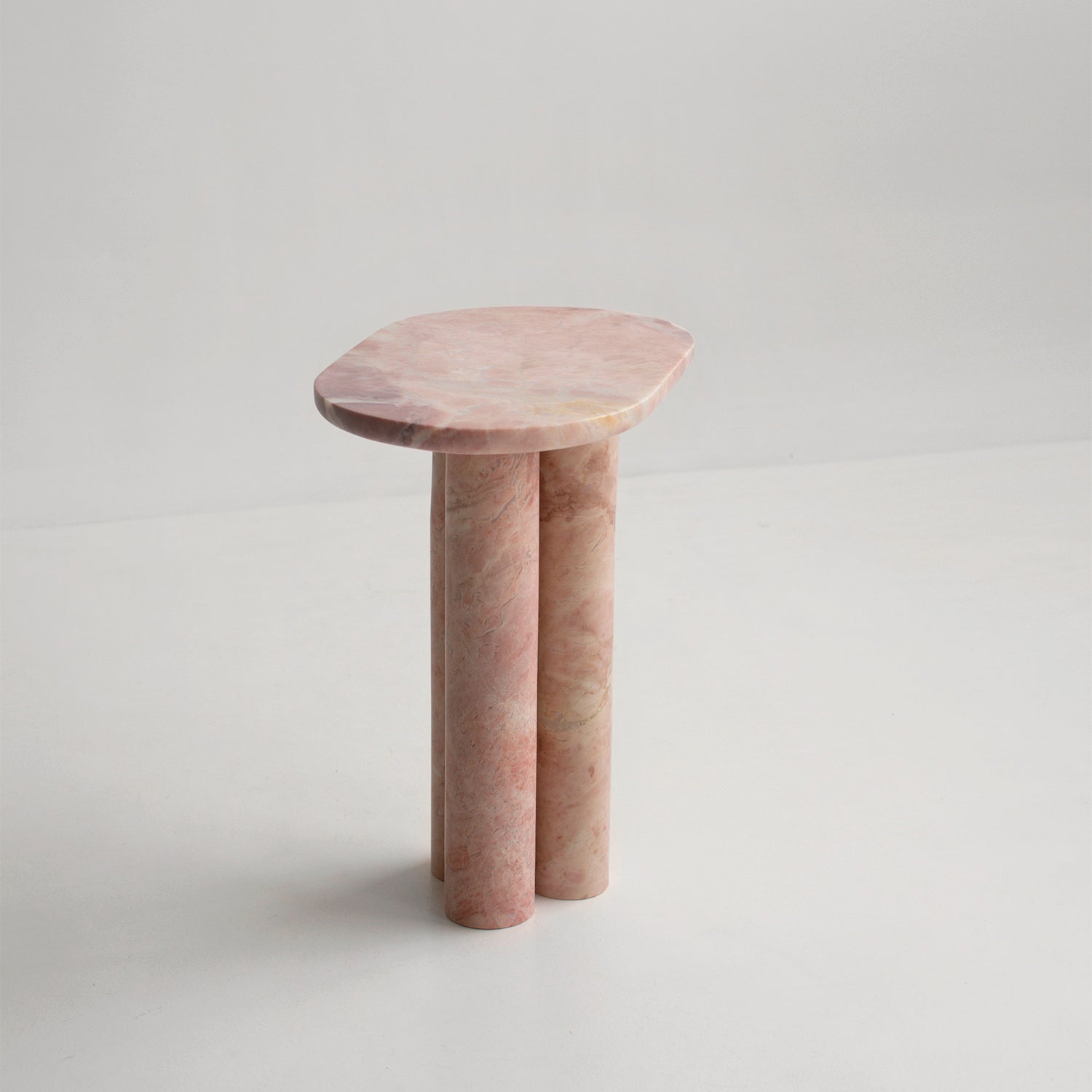 Pink marble side table with three round column legs