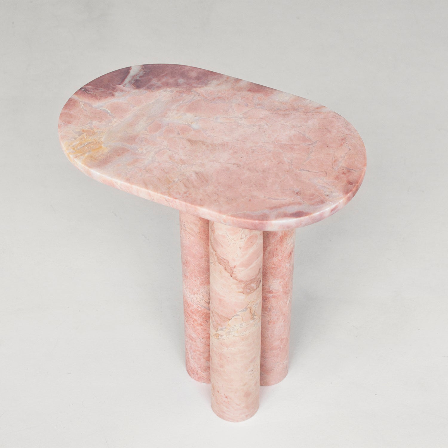 Pink marble side table with three round column legs