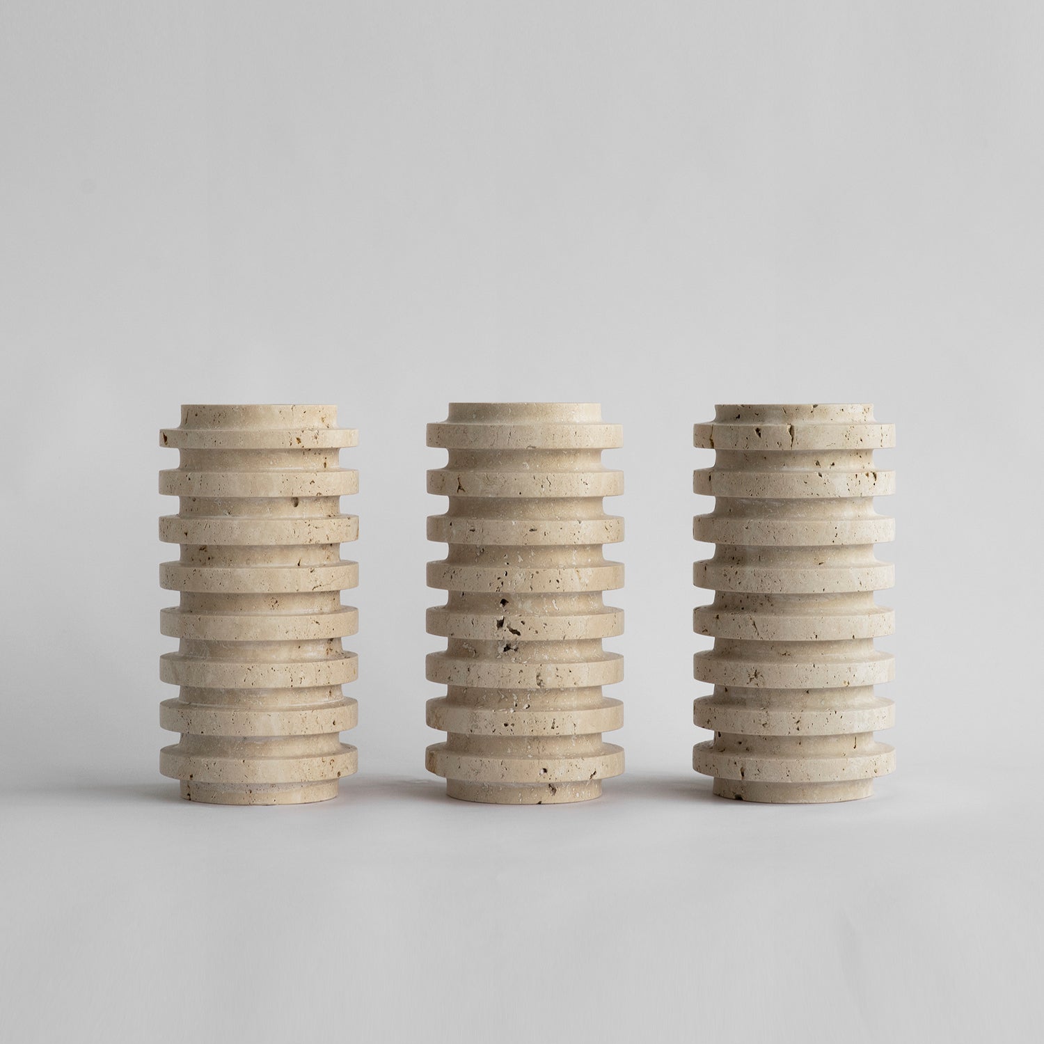 Travertine vase with natural stone layers on table