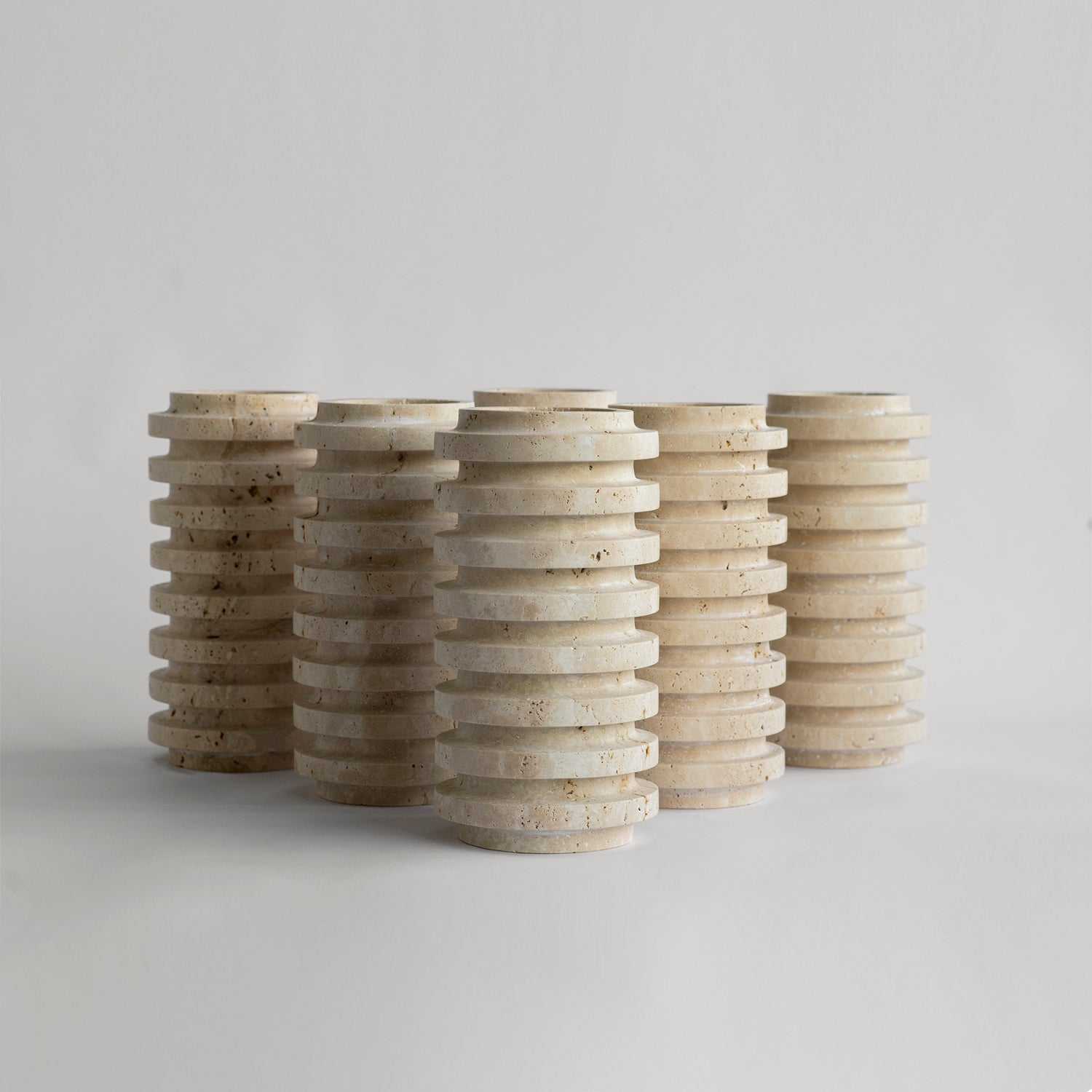 Travertine vase with natural stone layers on table