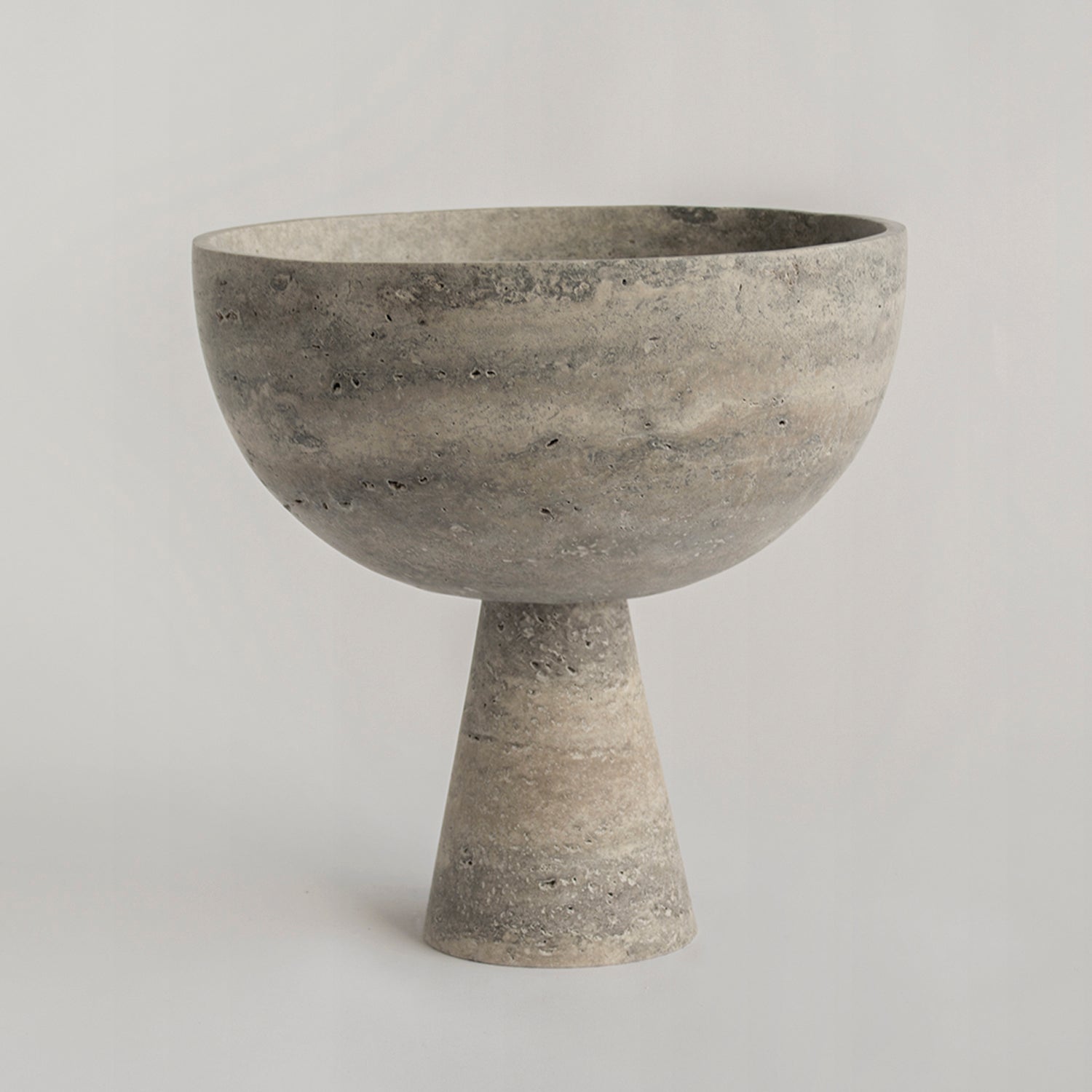 Silver travertine pedestal bowl with matte marble surface