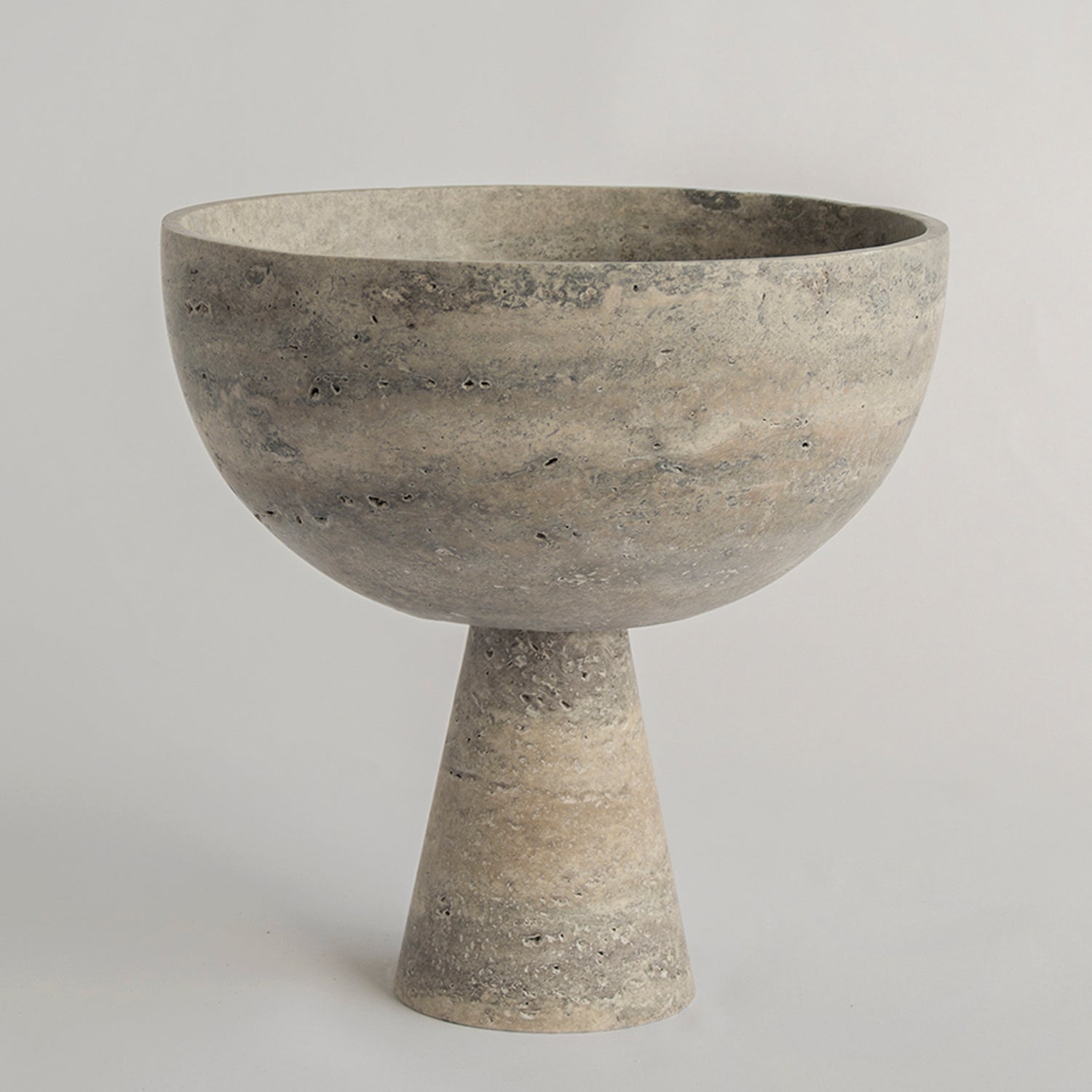 Silver travertine pedestal bowl with matte marble surface