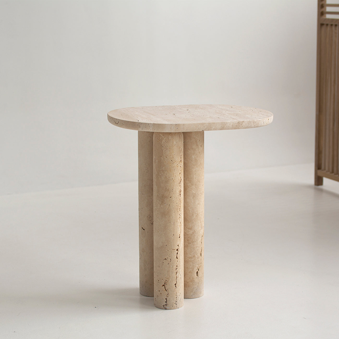Travertine side table with three stone cylinder legs