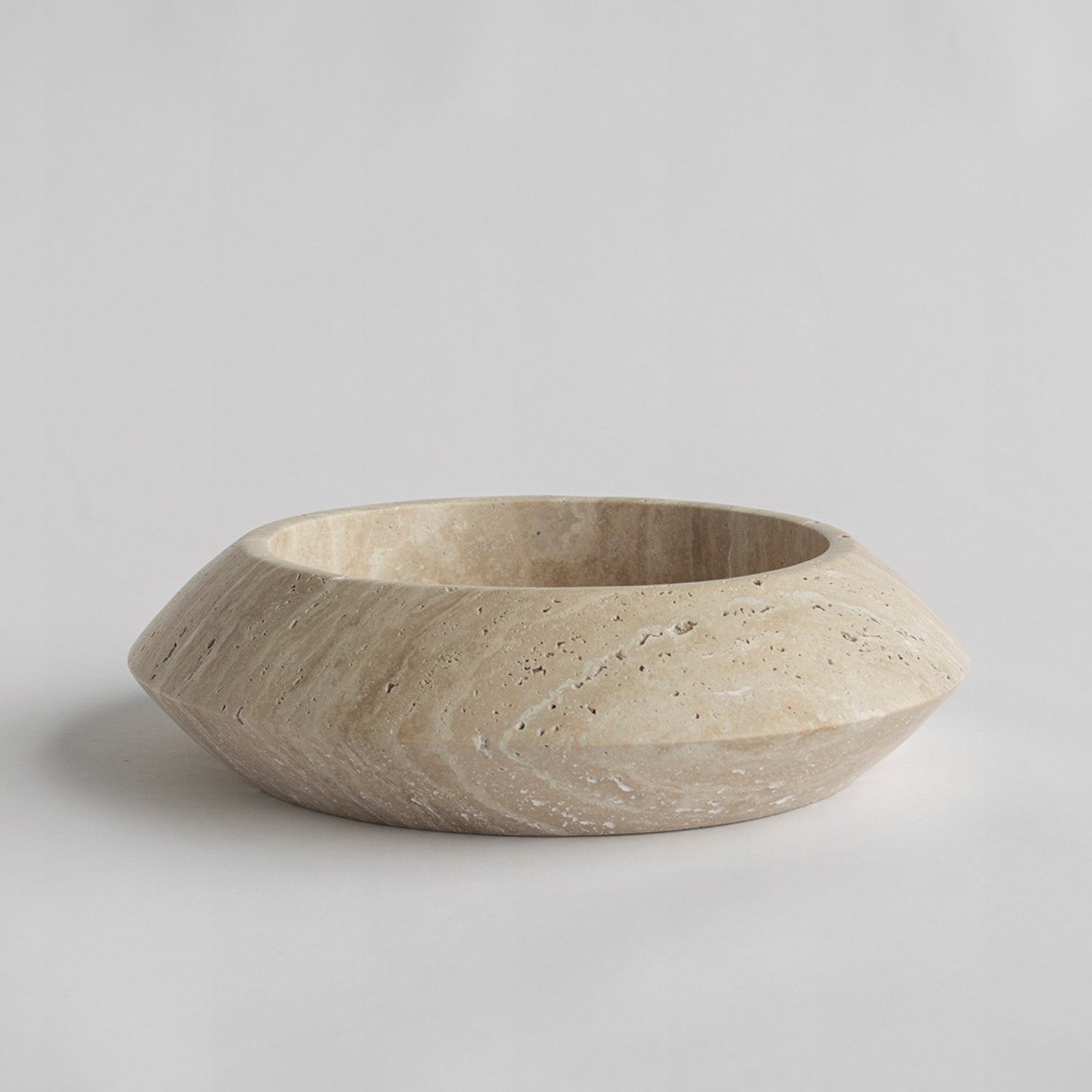 Decorative travertine bowl with natural stone texture