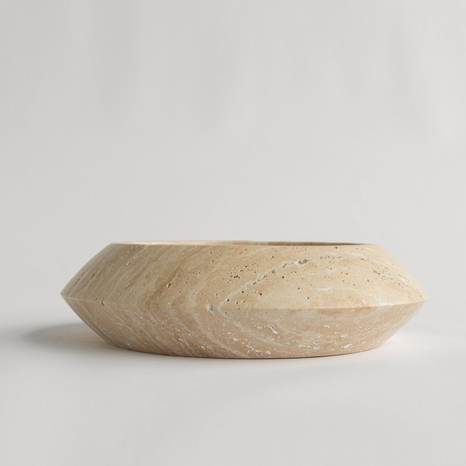 Decorative travertine bowl with natural stone texture