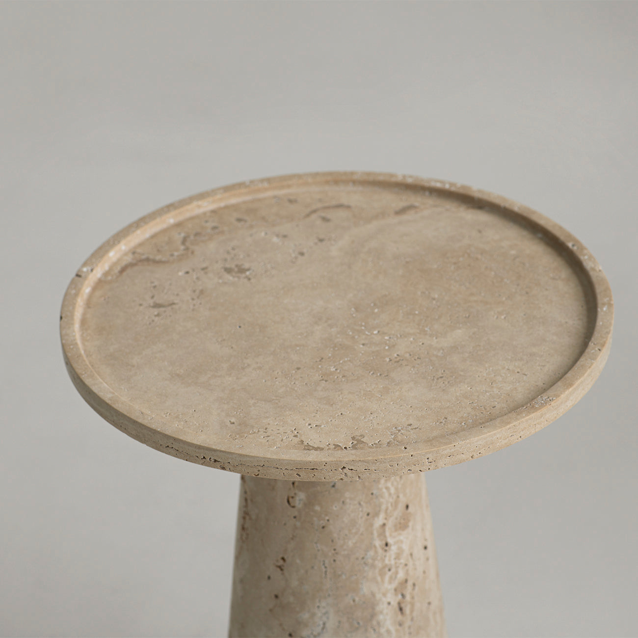 Travertine side table with cone pedestal and round top