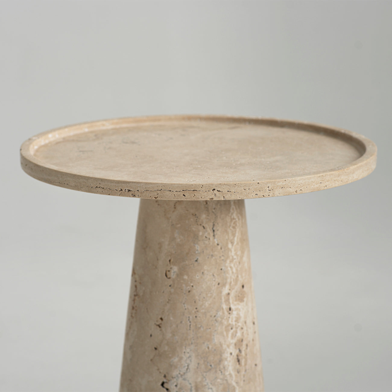 Travertine side table with cone pedestal and round top