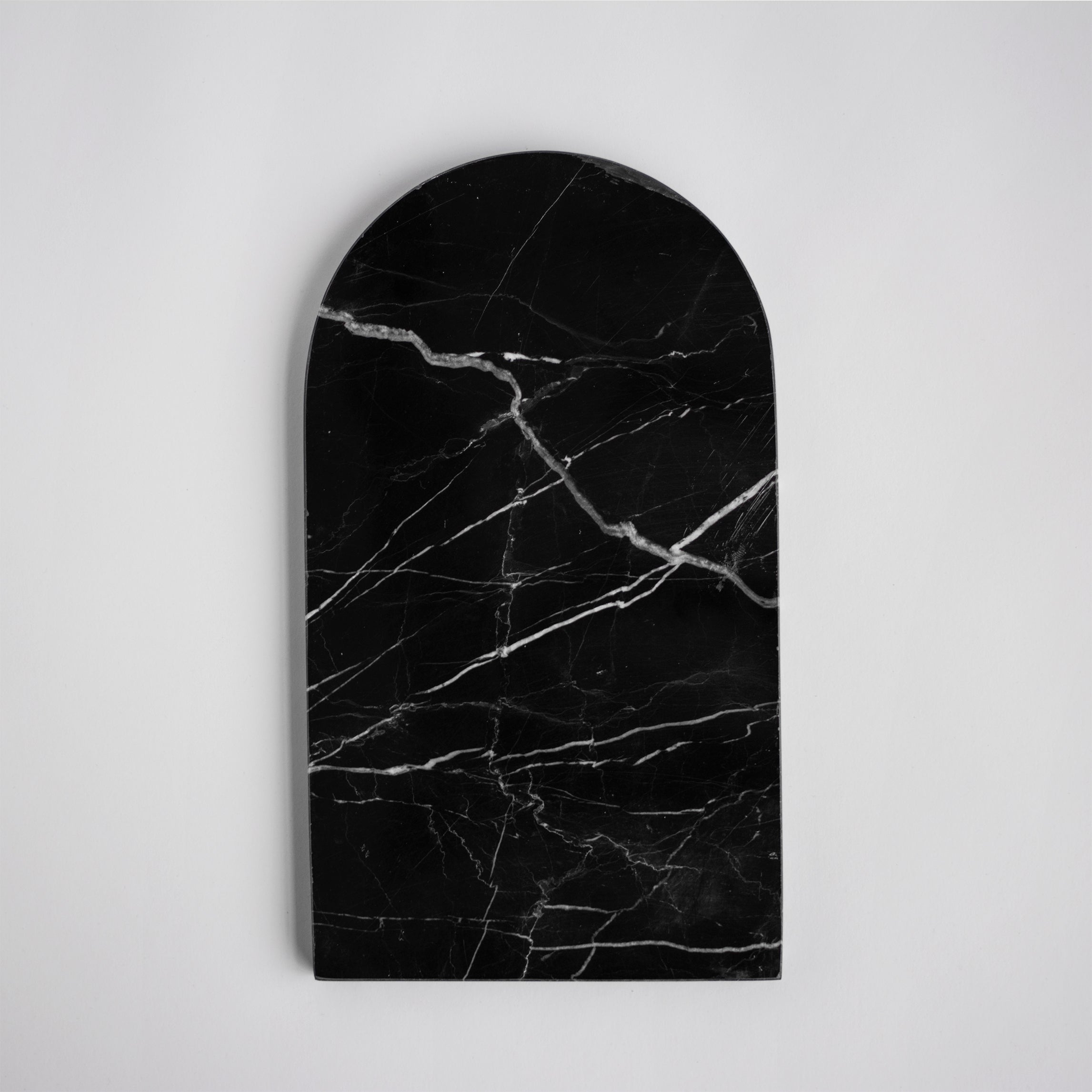Black marble platter with arched edge on table